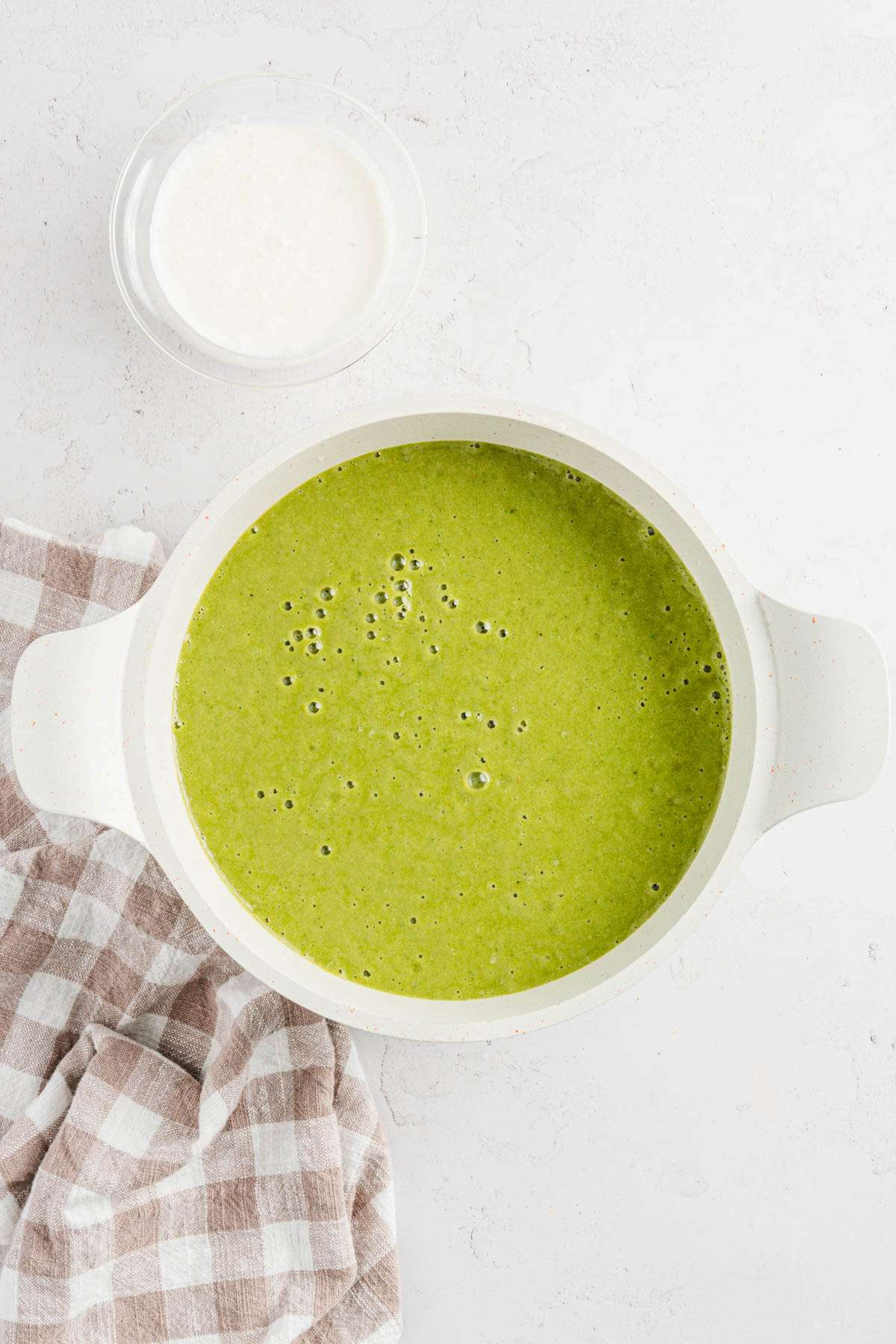 blended fava bean soup, small bowl with cream