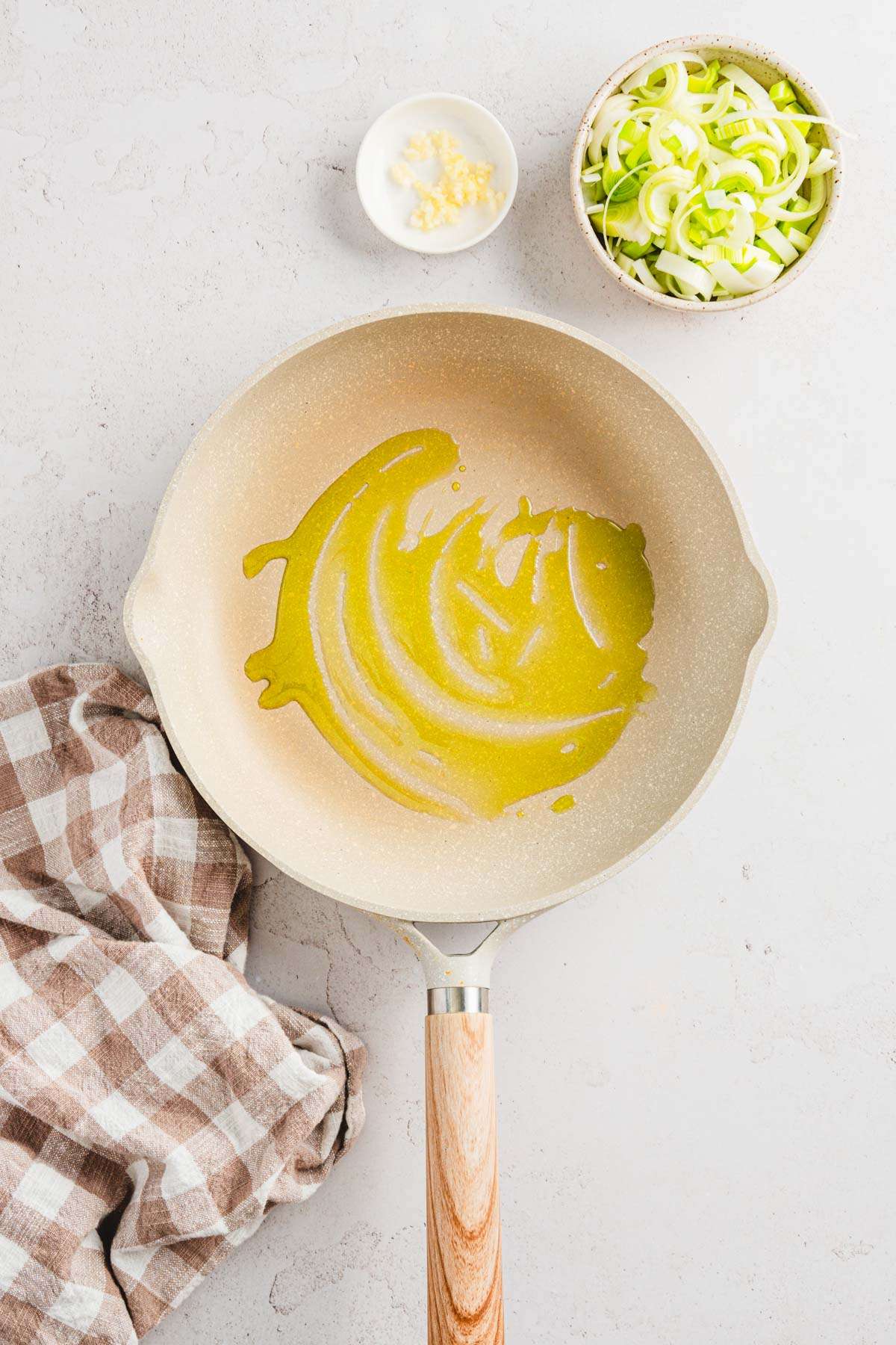 skillet with a drizzle of dill oil spread out on it