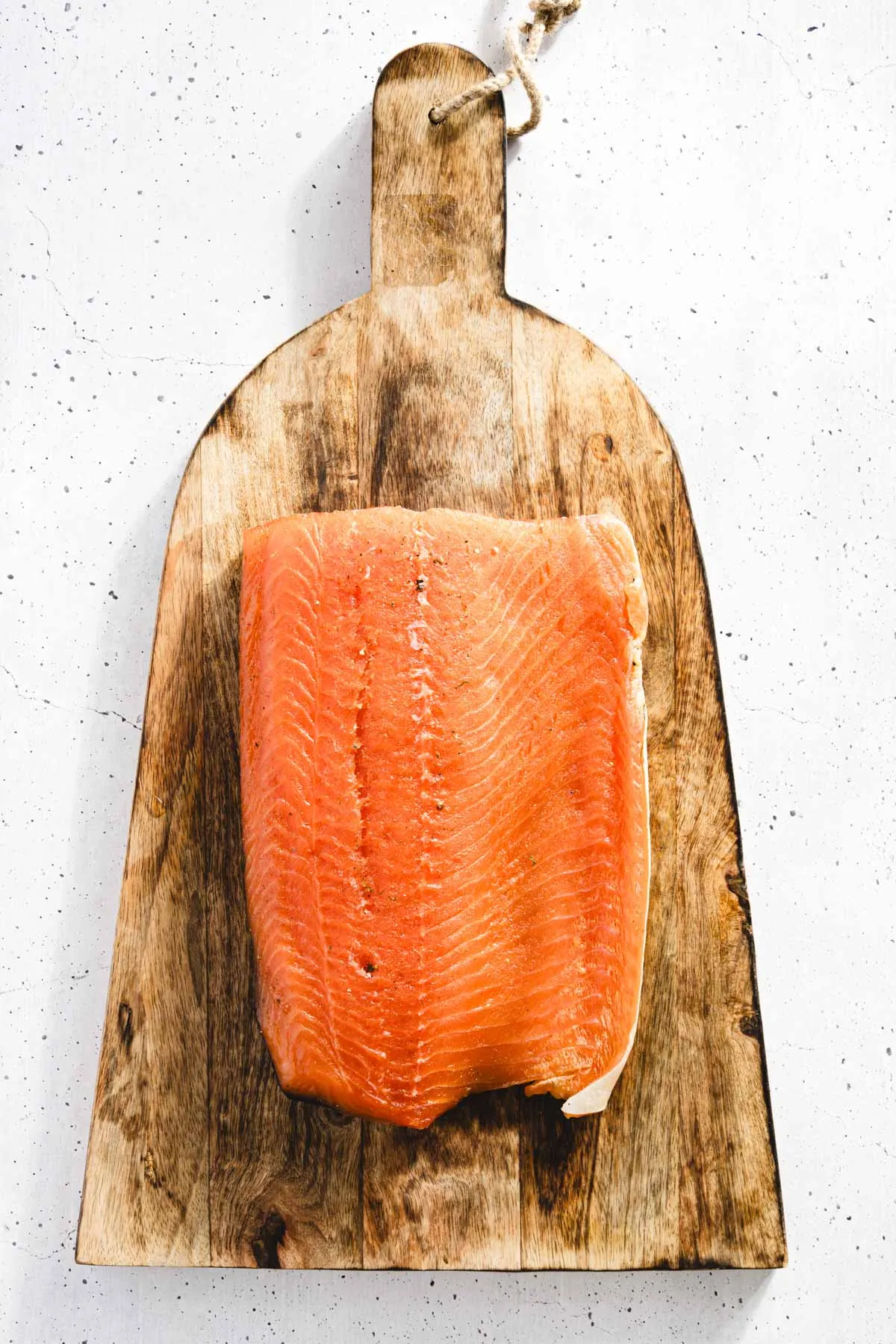 cured salmon placed on wooden cutting board