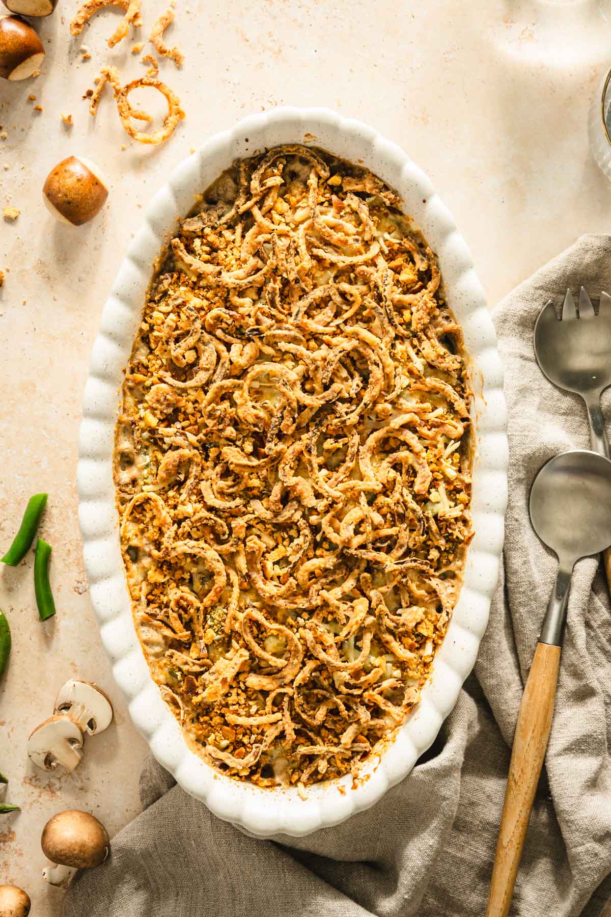 baked green bean casserole presented in the deep dish, serving spoons, napkin