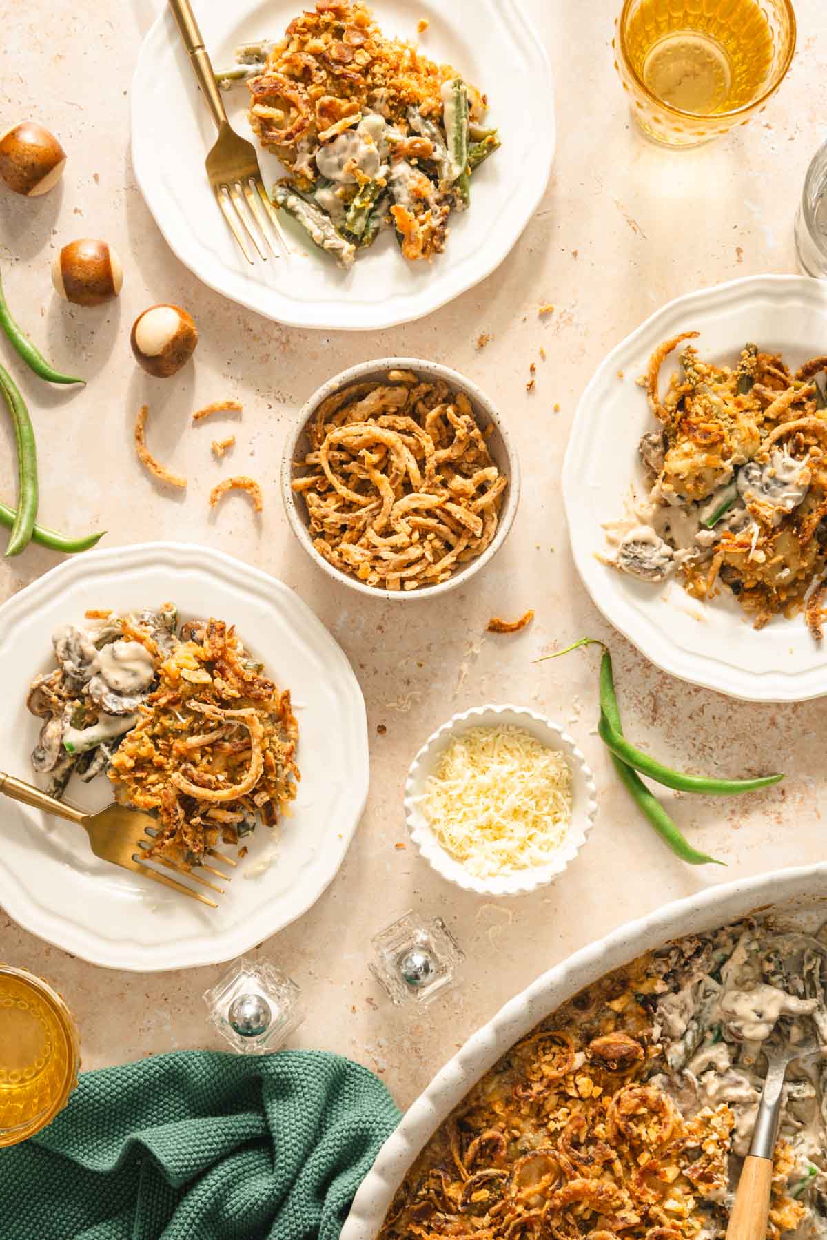 plates with casserole, glasses with water, utensils, napkin