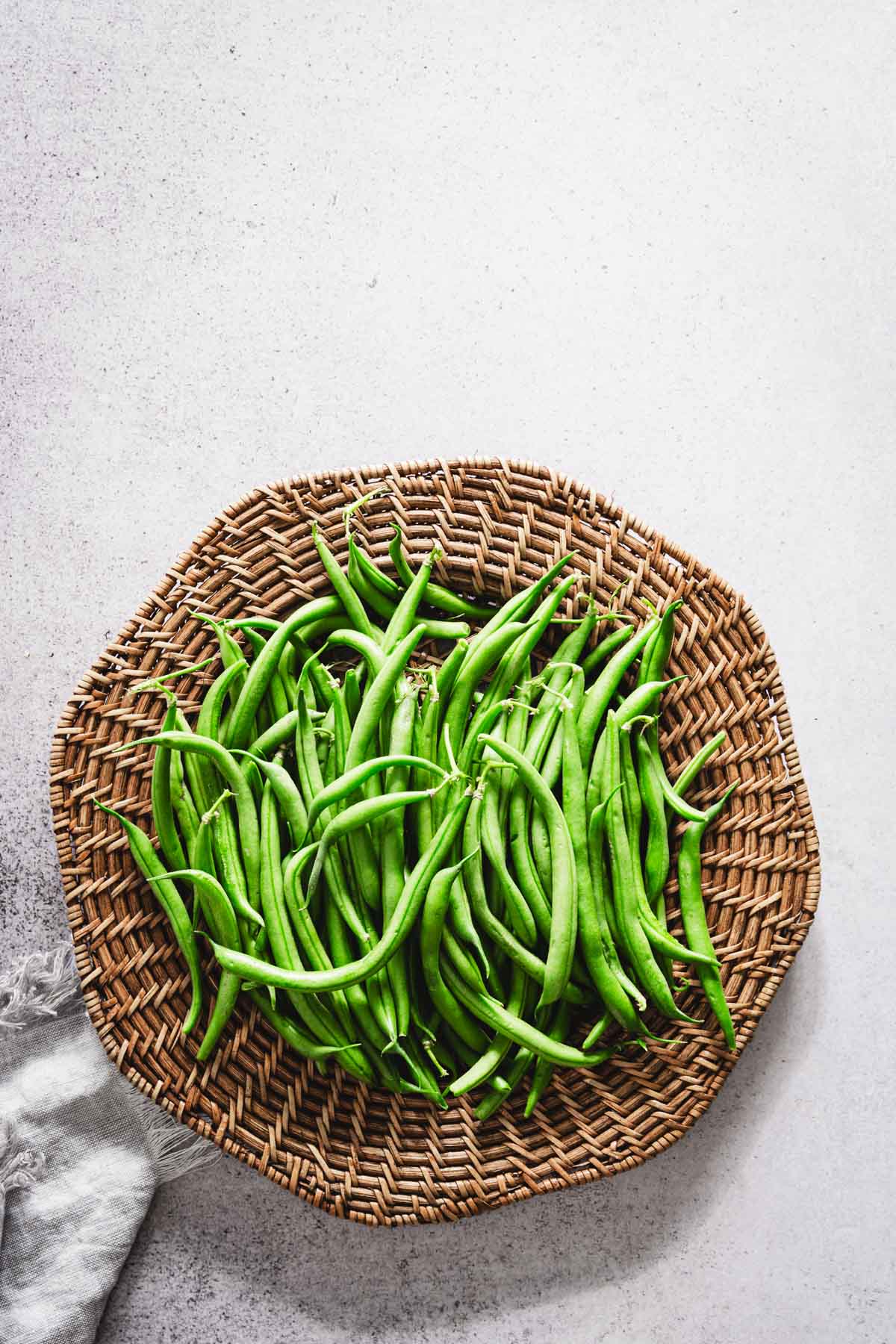 green beans arranged on a wooden platter