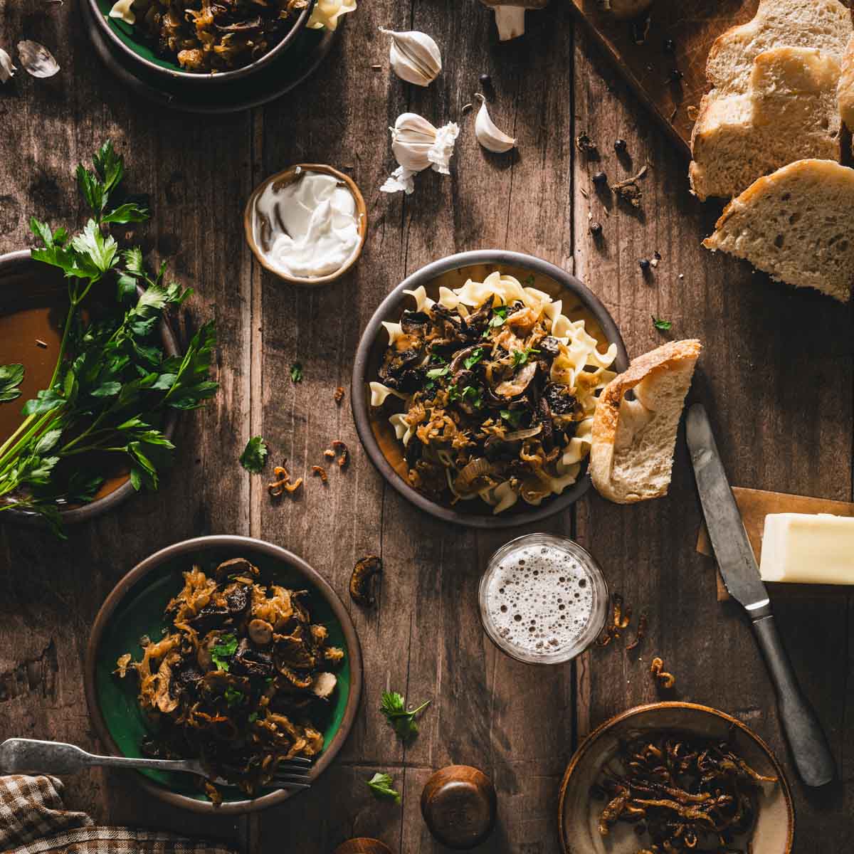 dish wiht kapusta, other plates, slices of bread, fresh parsley