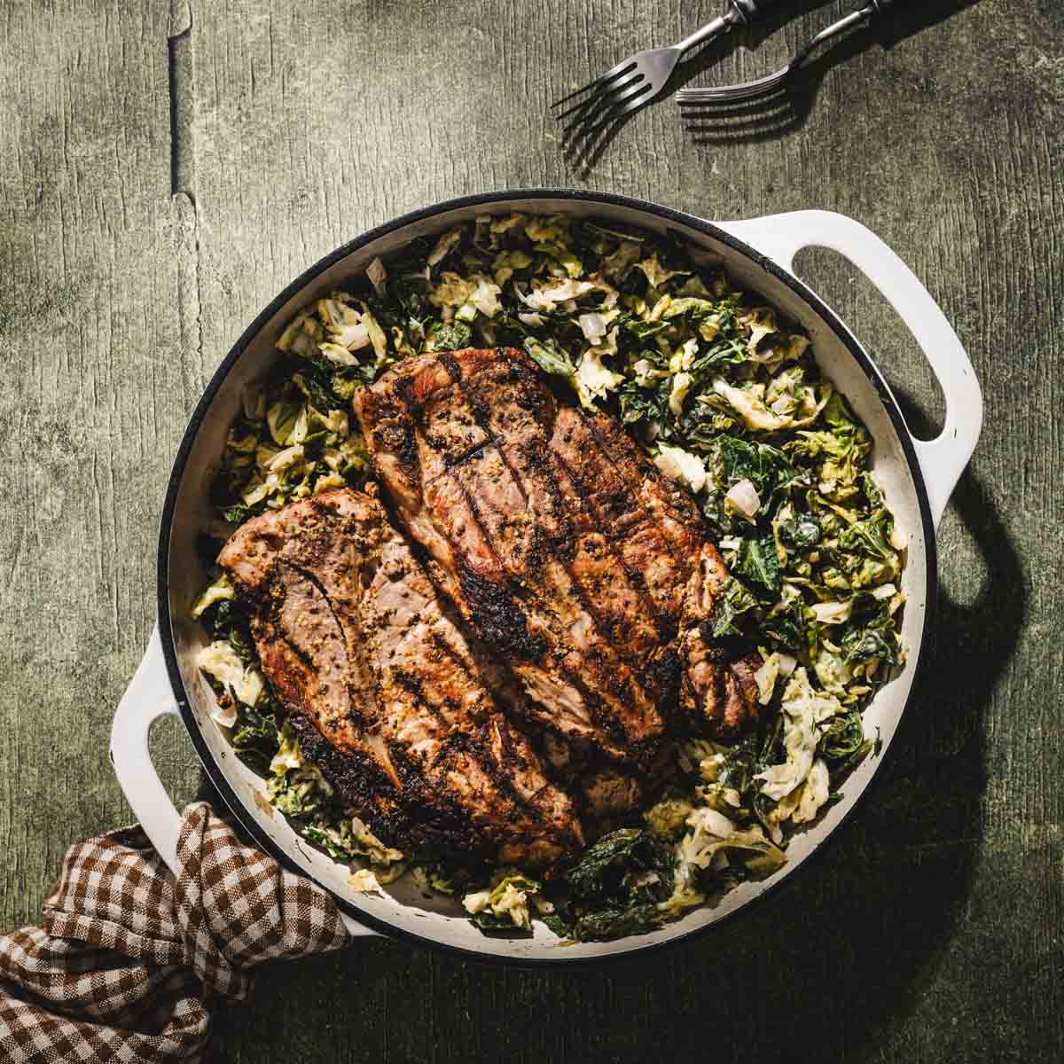 grilled karkowka served over braised cabbage