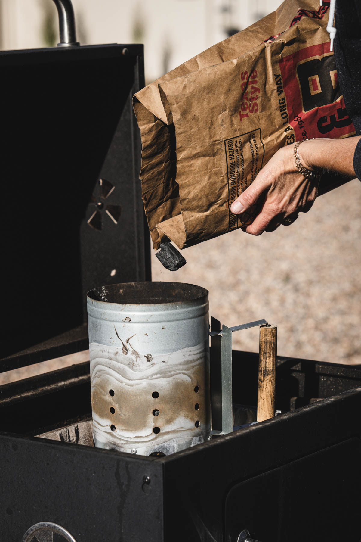 hands in frame holding bag with charcoal