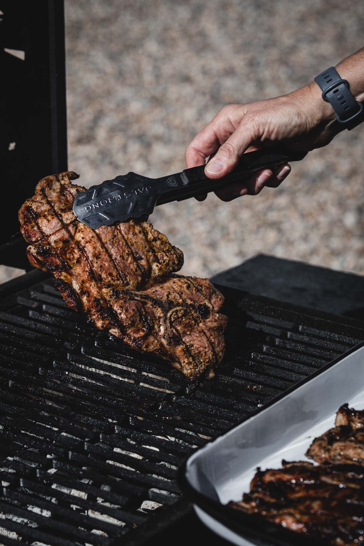 hands in frame holding tongs and piece of karkowka