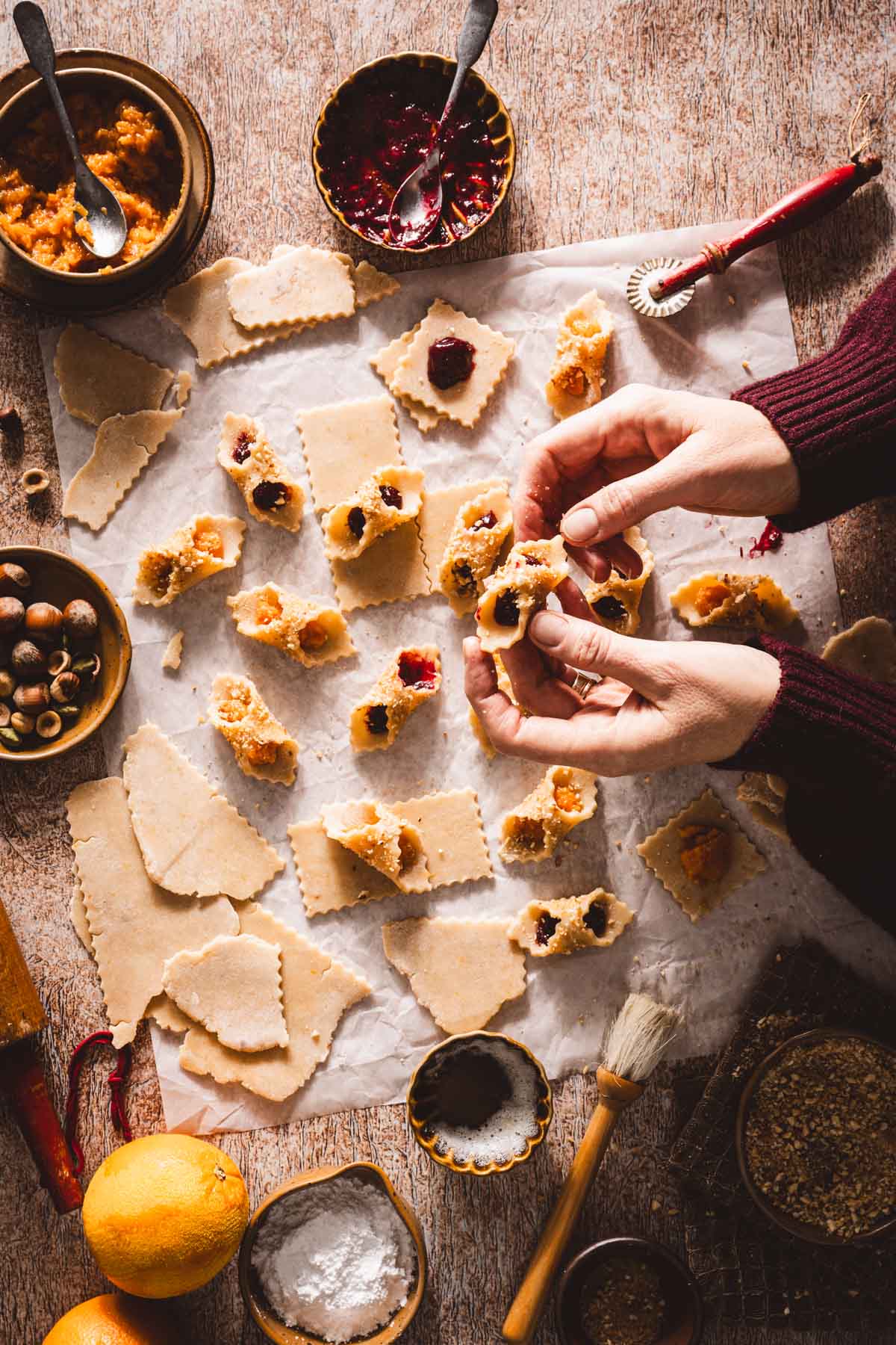 hands in frmae holding kolaczki cookie