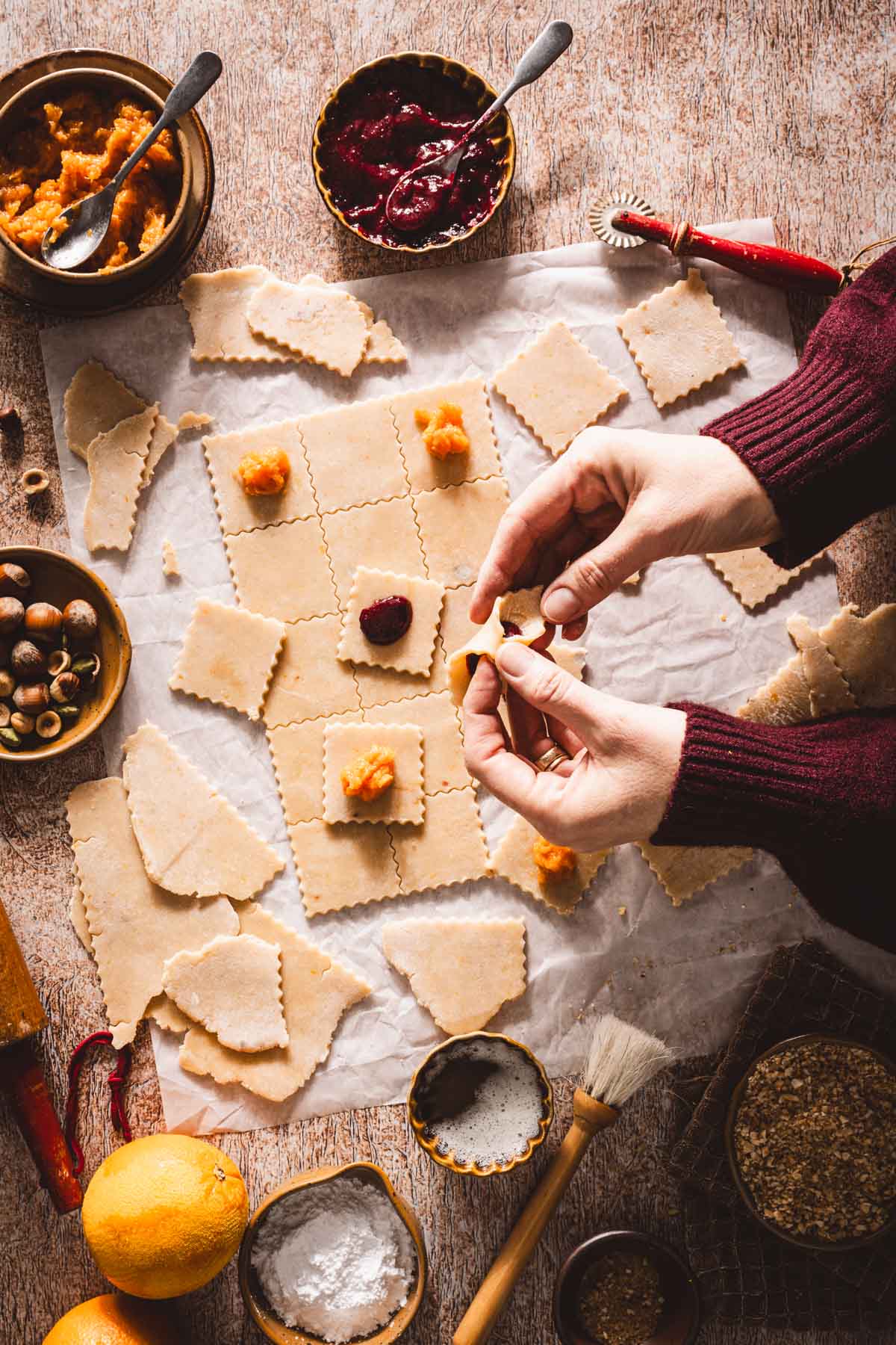 hands in frame pinching the edges of the squares