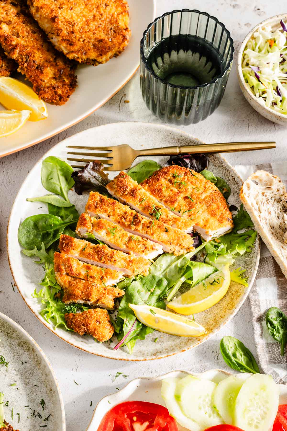 sliced pork chop on a plate with salad