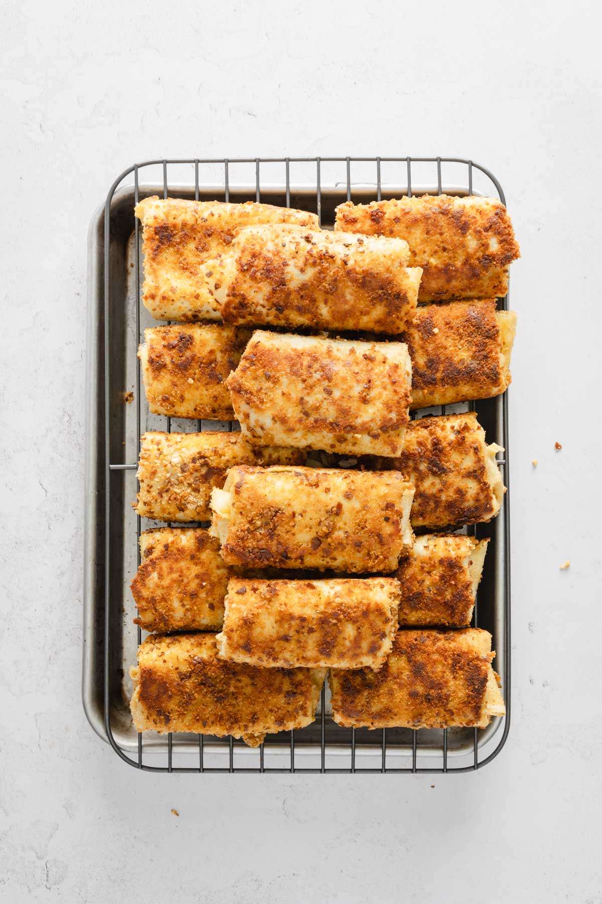 fried and cooked krokiety on a baking tray