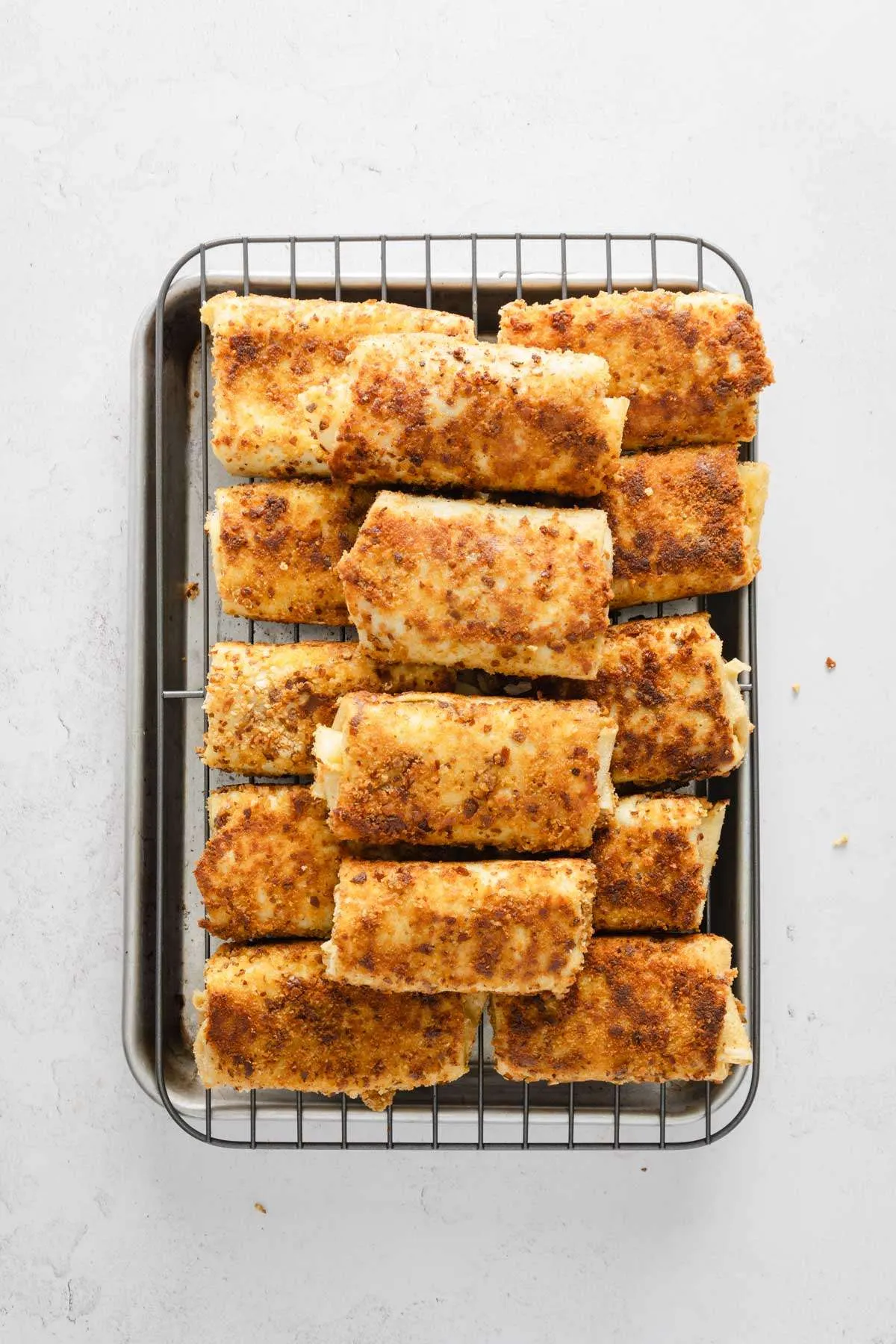fried and cooked krokiety on a baking tray
