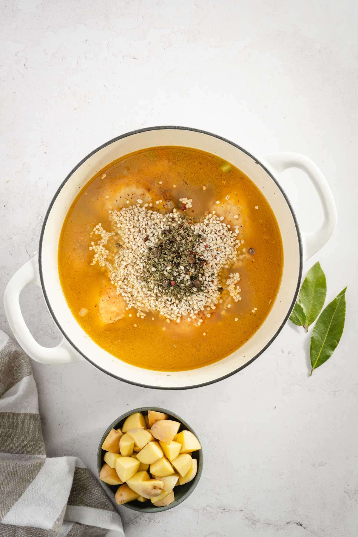 added barley to the pot with broth, chicken and veggies, added aromatics, added herbs