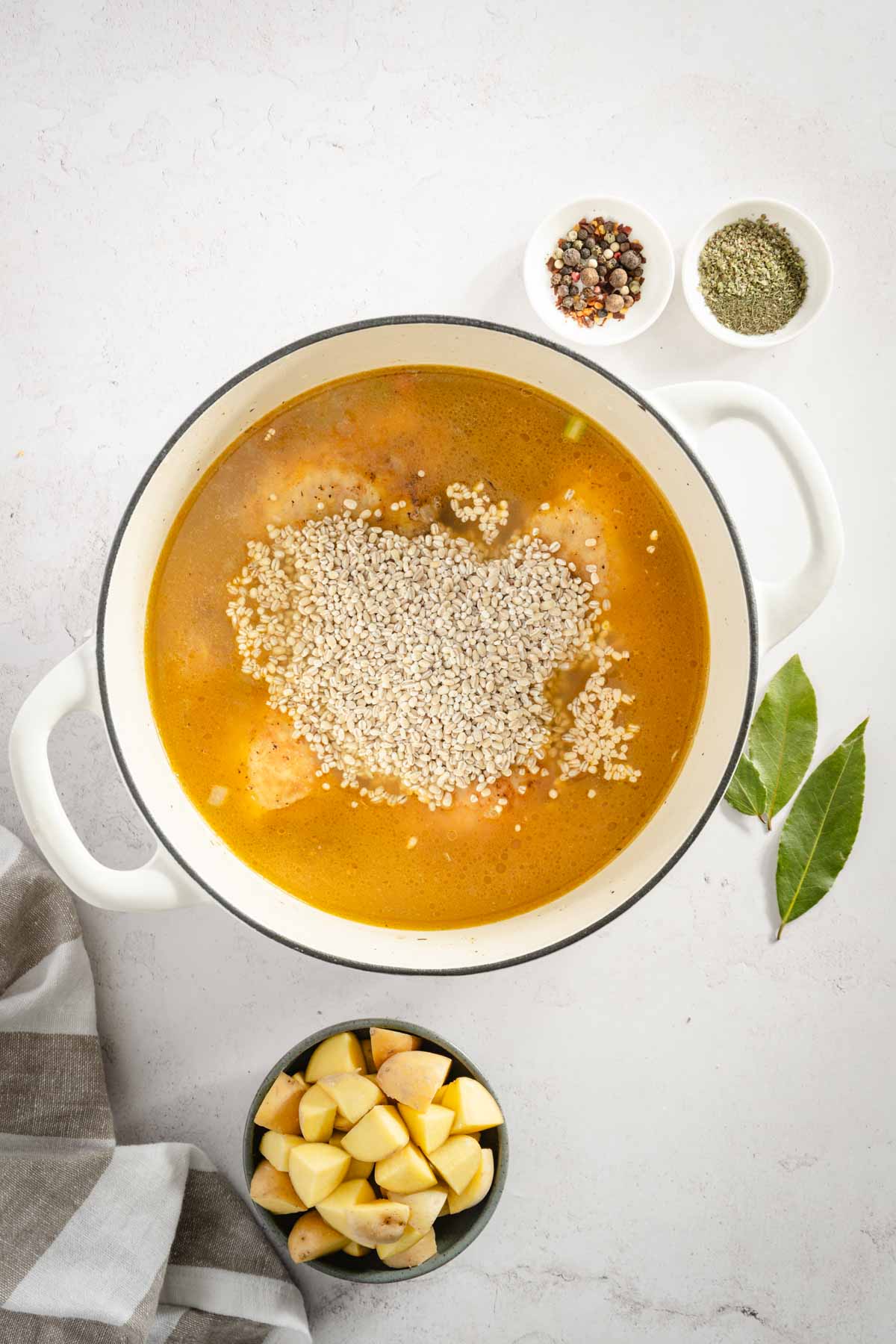 added barley to the pot with broth, chicken and veggies