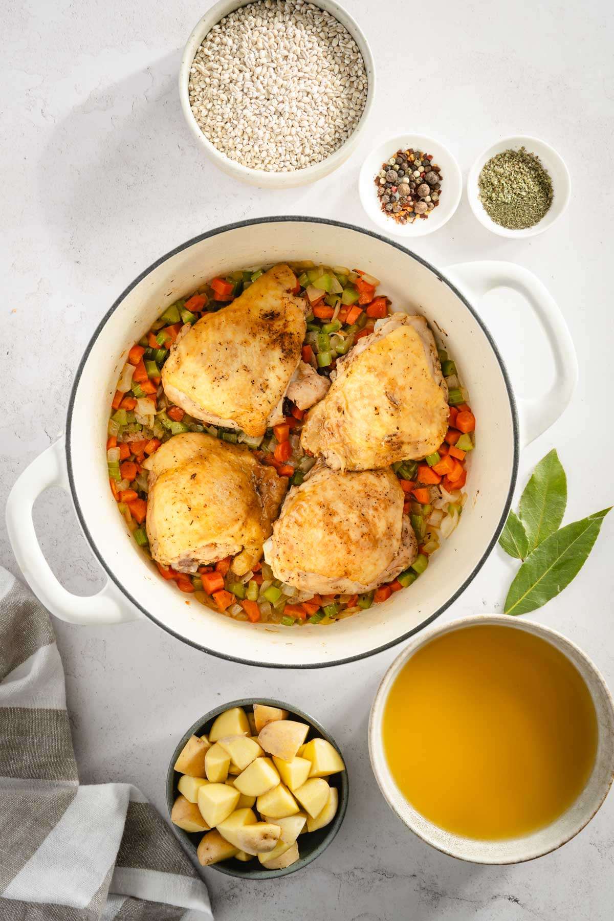 cooked chicken in the pot on top of the veggies