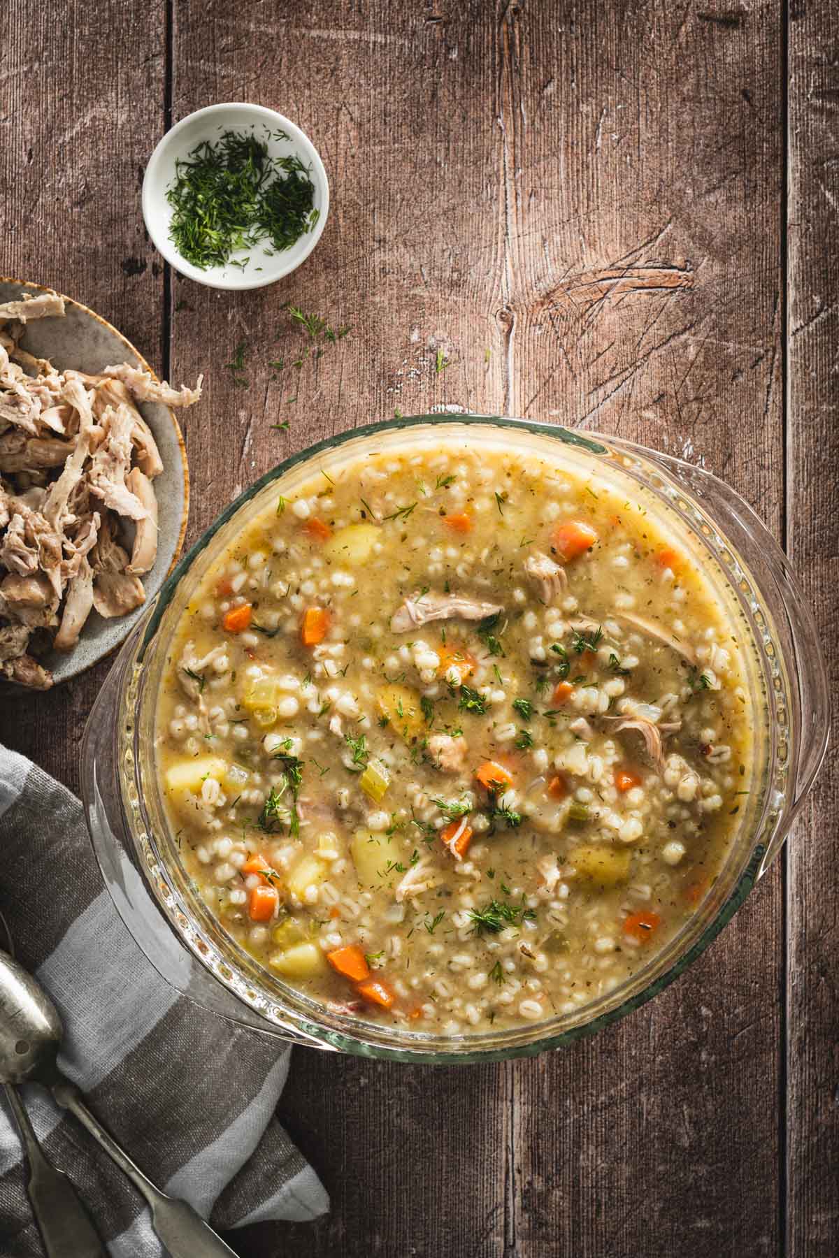 Krupnik in a serving bowls, wooden background