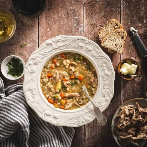 Krupnik in a serving bowls, wooden background