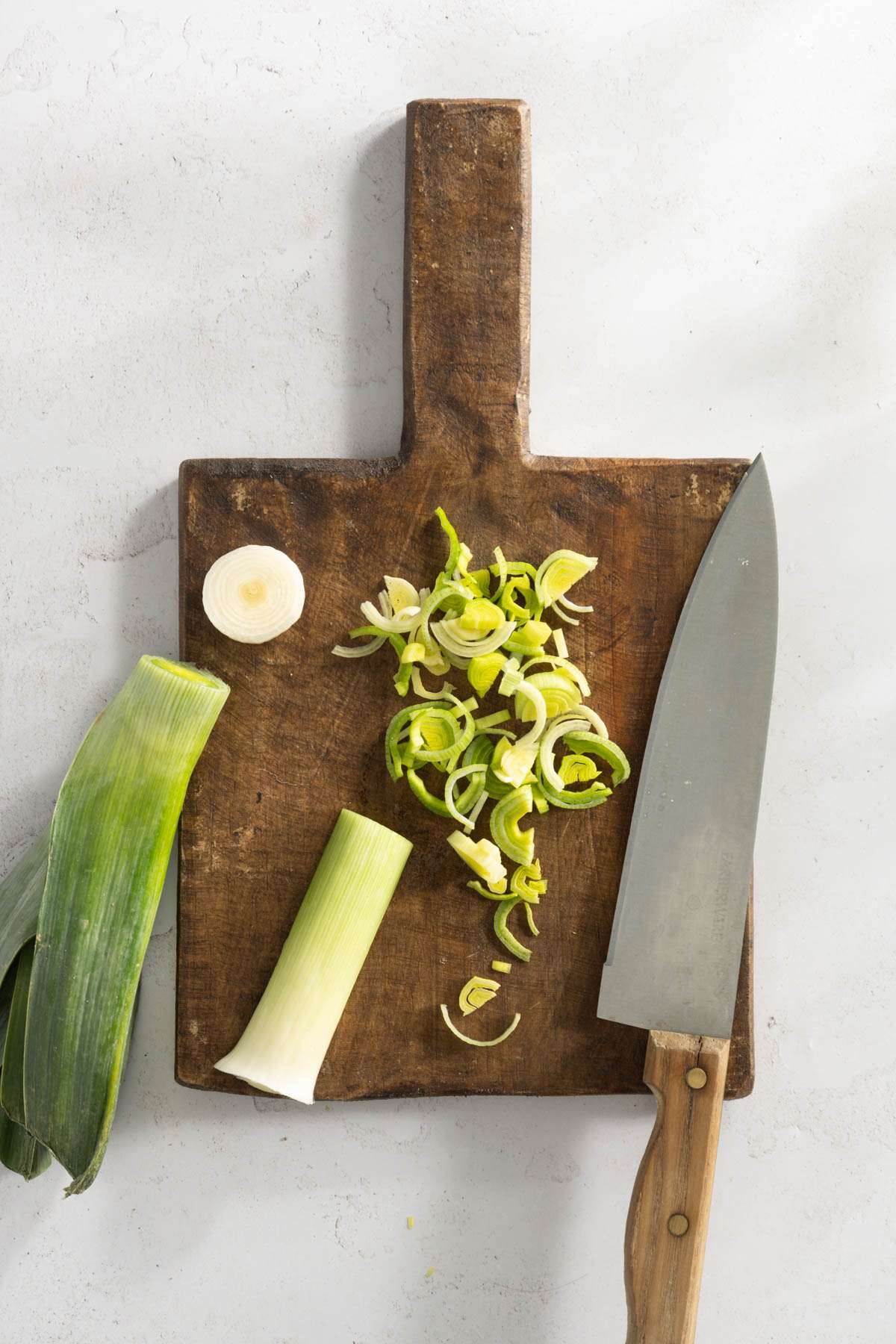 leek on a cutting board, sliced thinnly