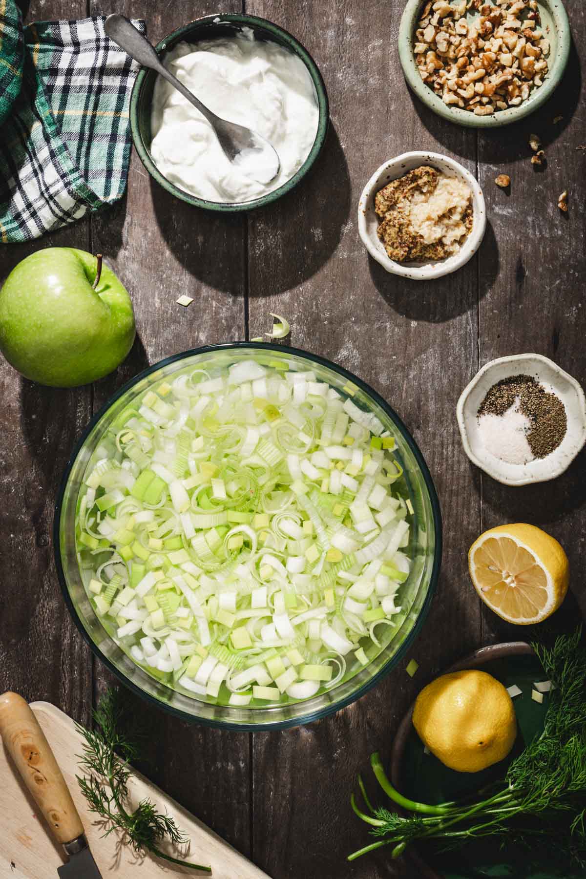 leeks in a water bath in a glass bowl