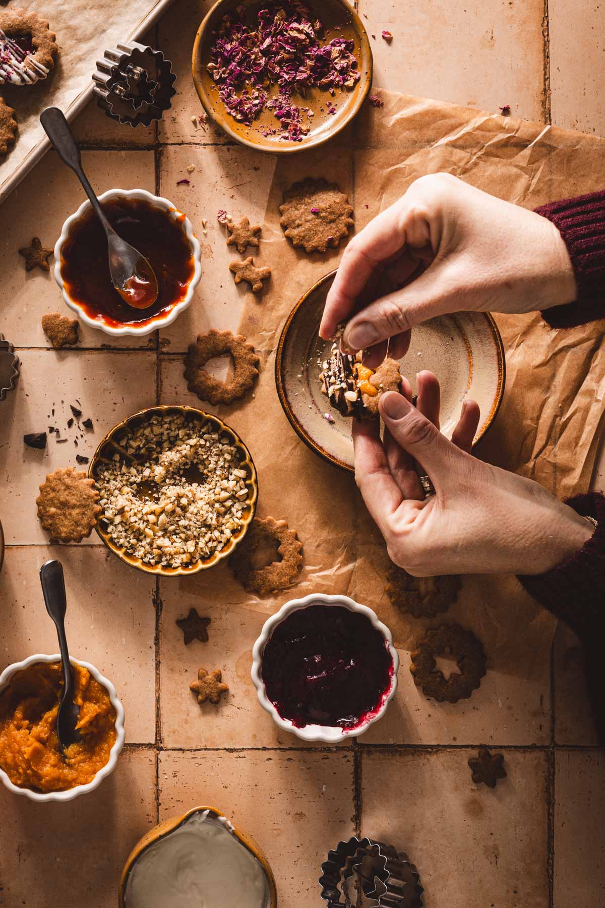 hands in frame adding nuts to the cookie