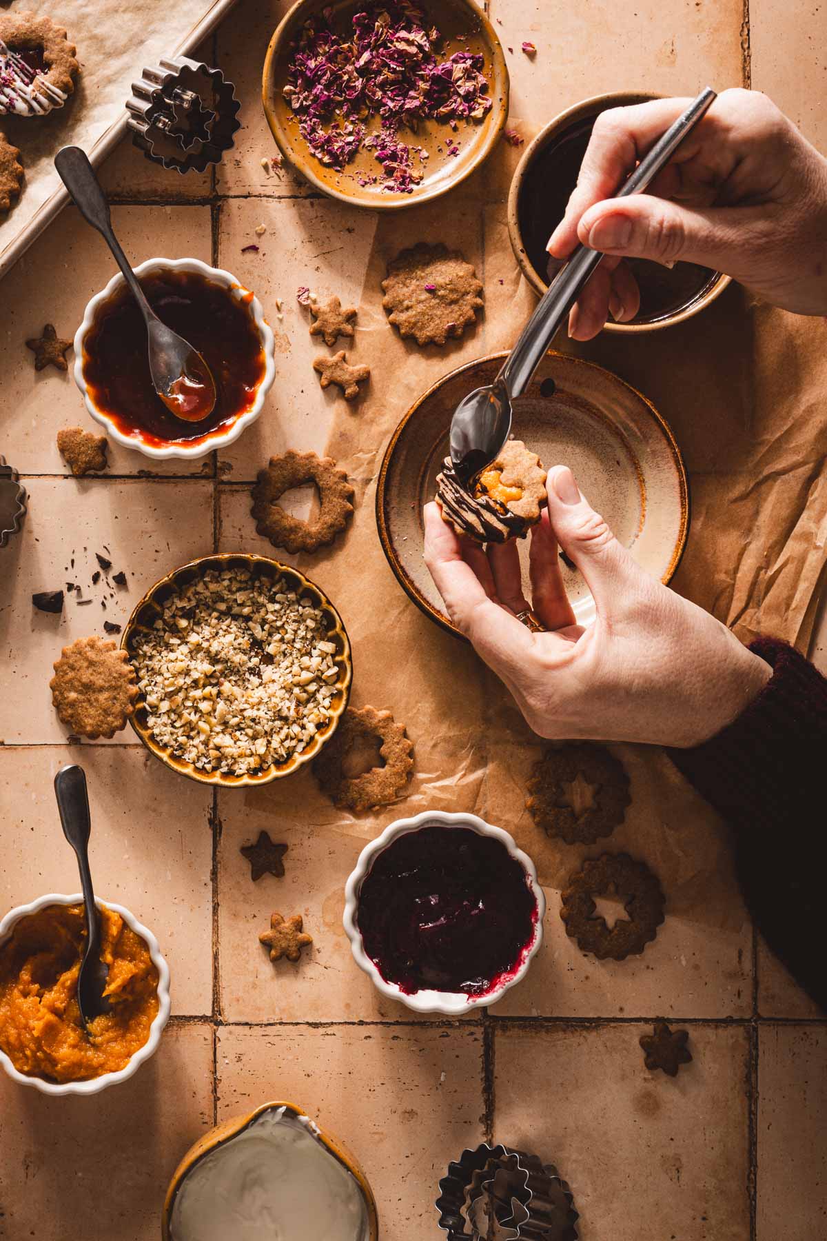 hands in frame drizzeling chocolate ove rthe cookie