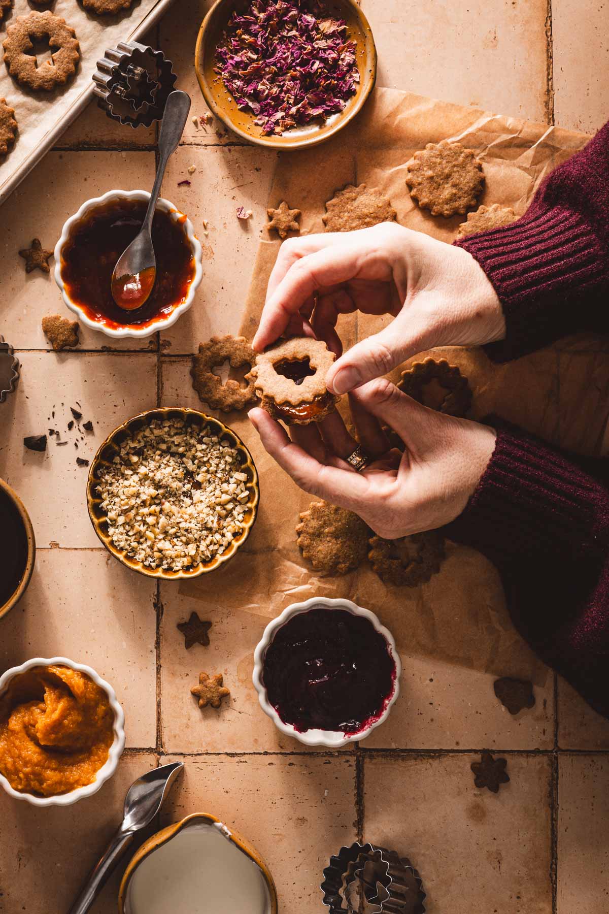 hands in frame adding top cookie