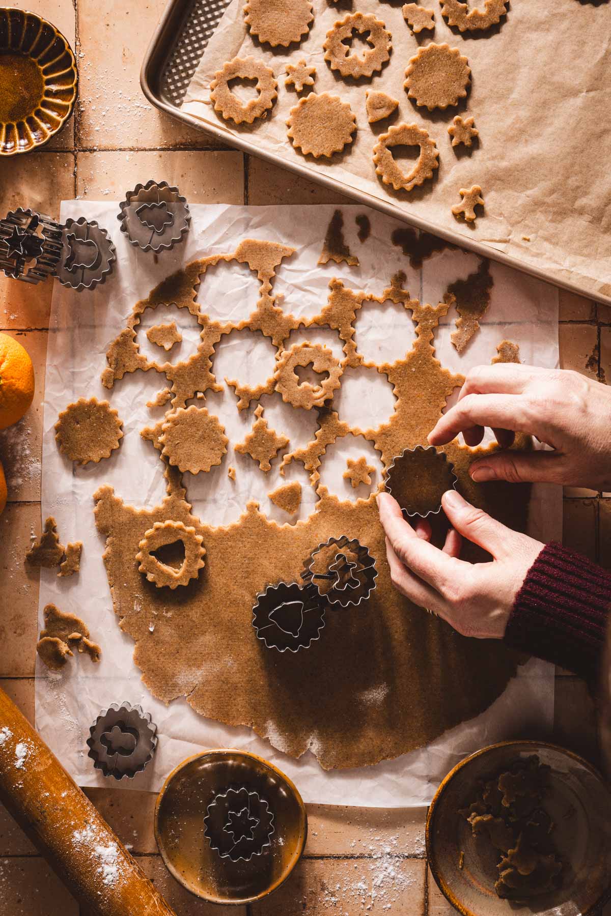 hands in frame cutting out the cookies