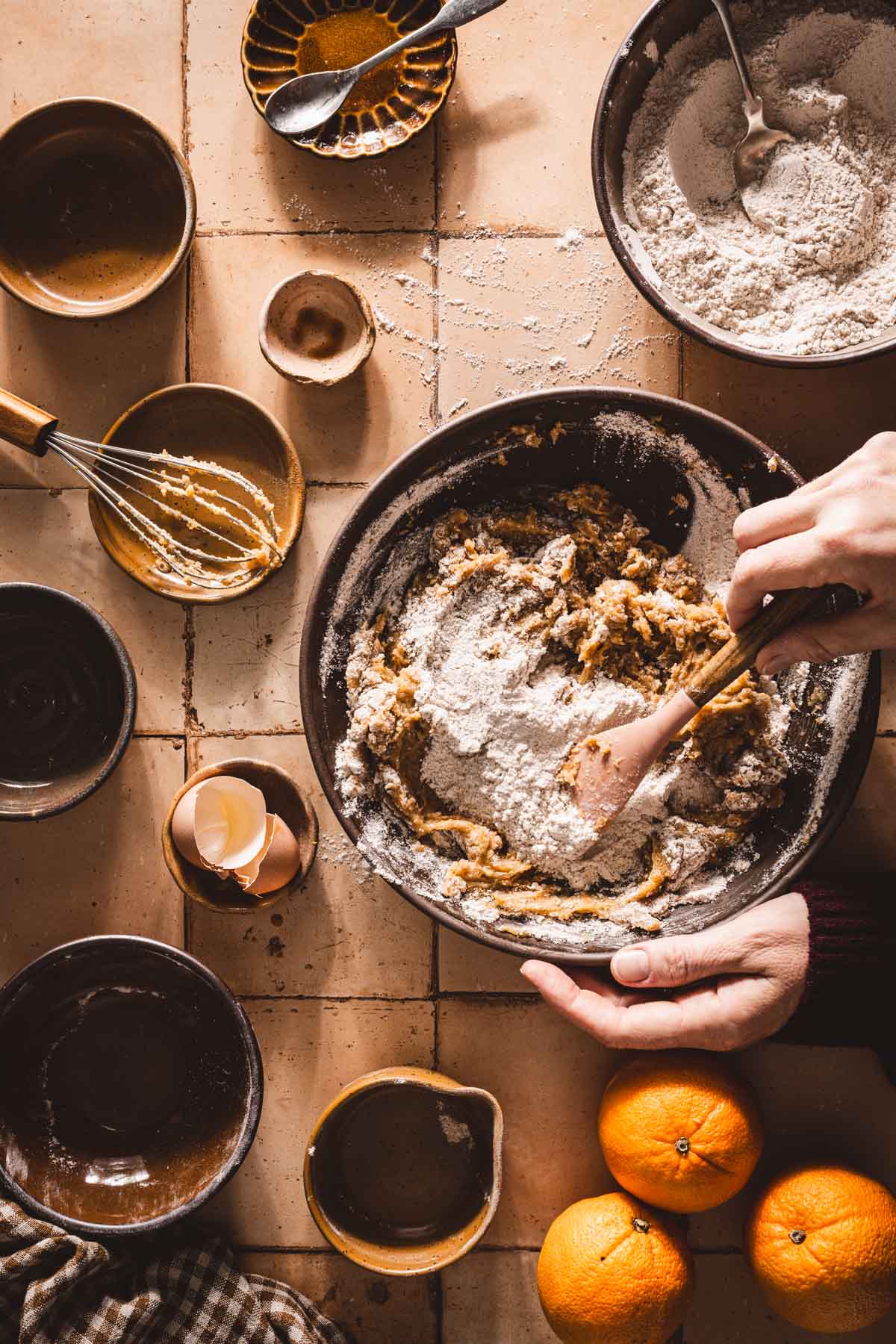 hands in frame mixing flour into the batter