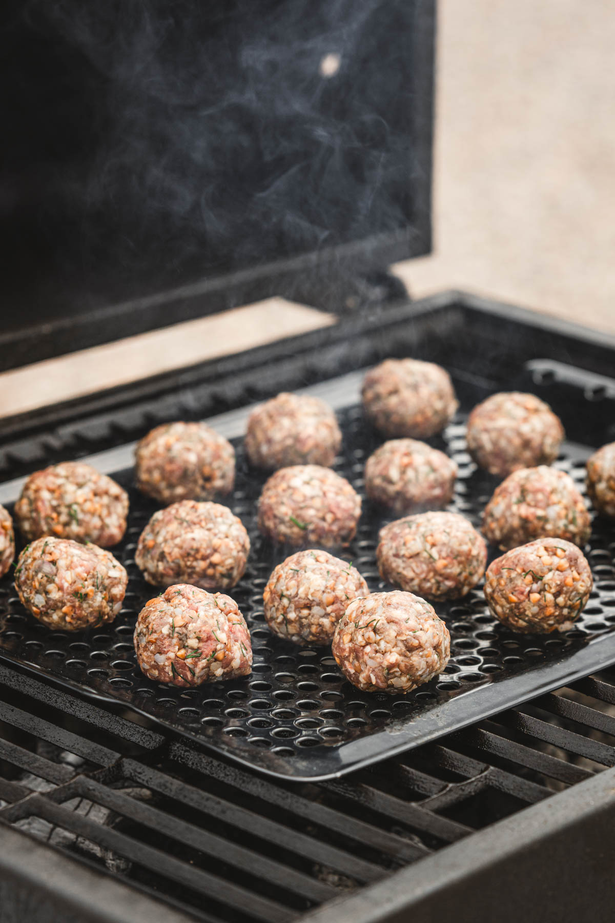 raw meatballs on grill grates