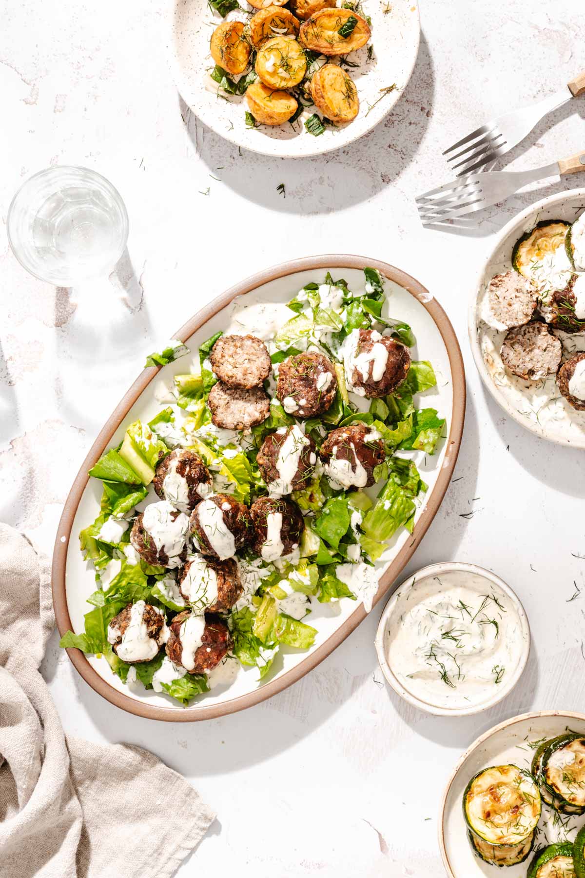 meatballs on a serving platter, few other plates around