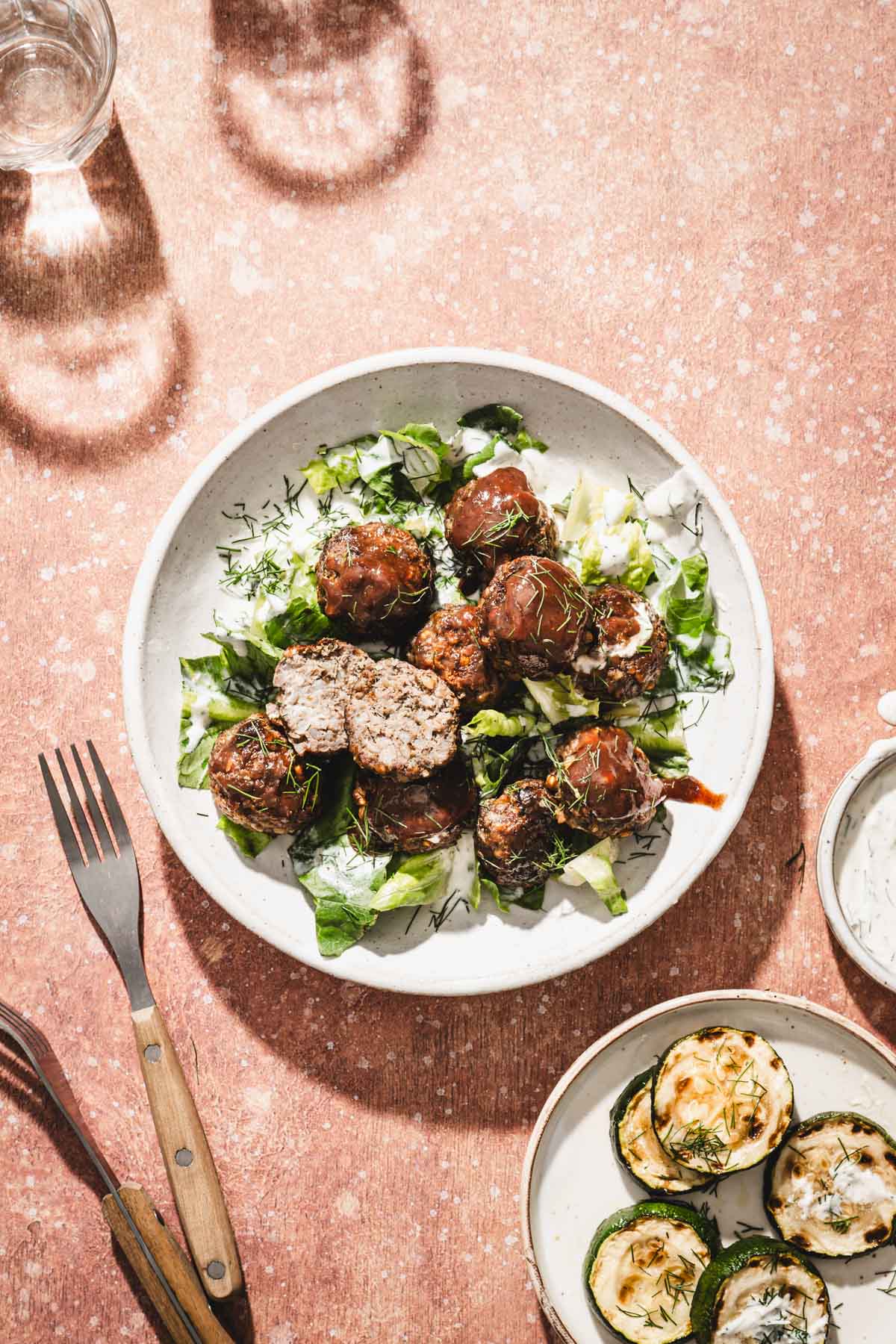 top view of a plate with meatballs, side dish sauce,