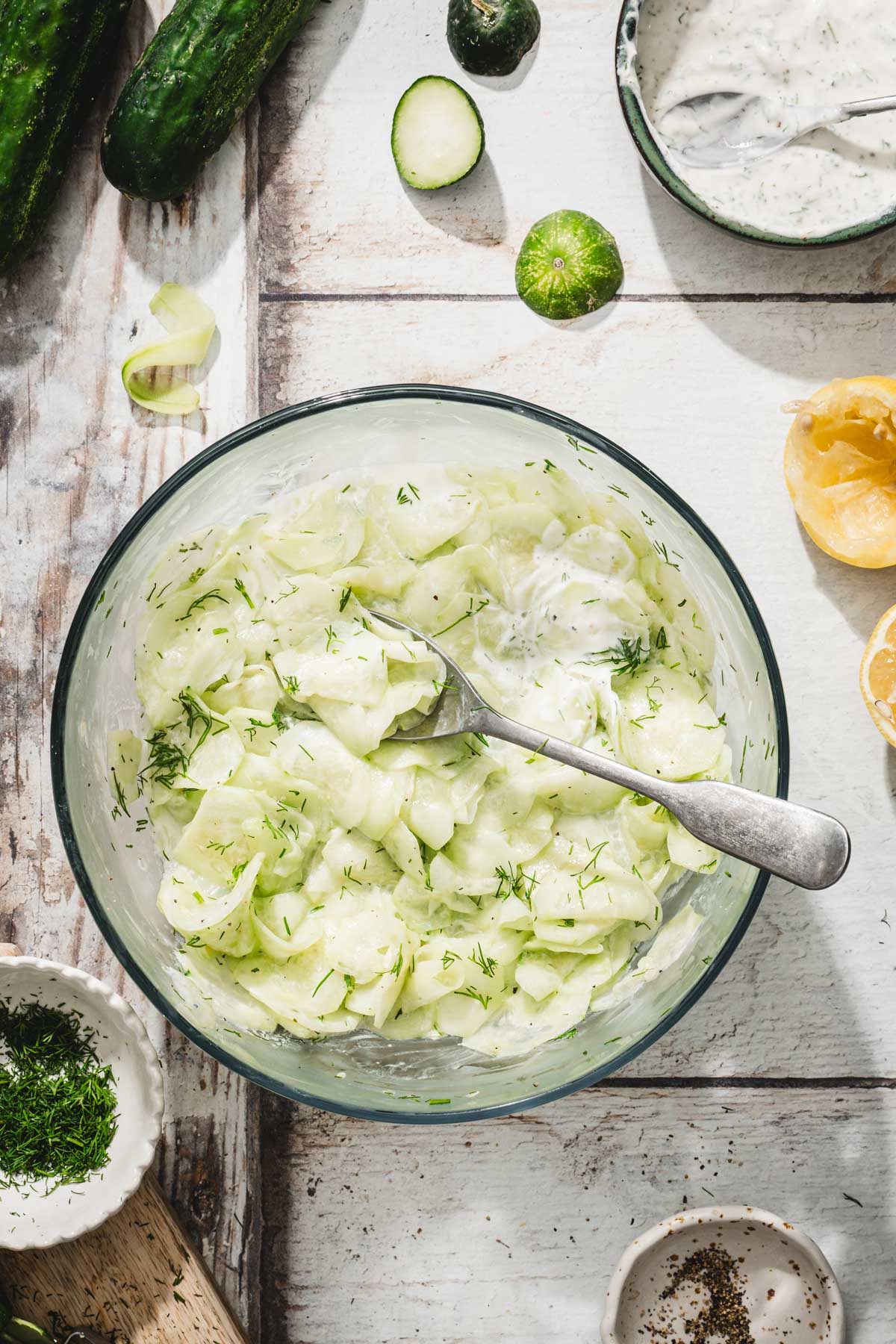 mizeria in a glass bowl, serving spoon