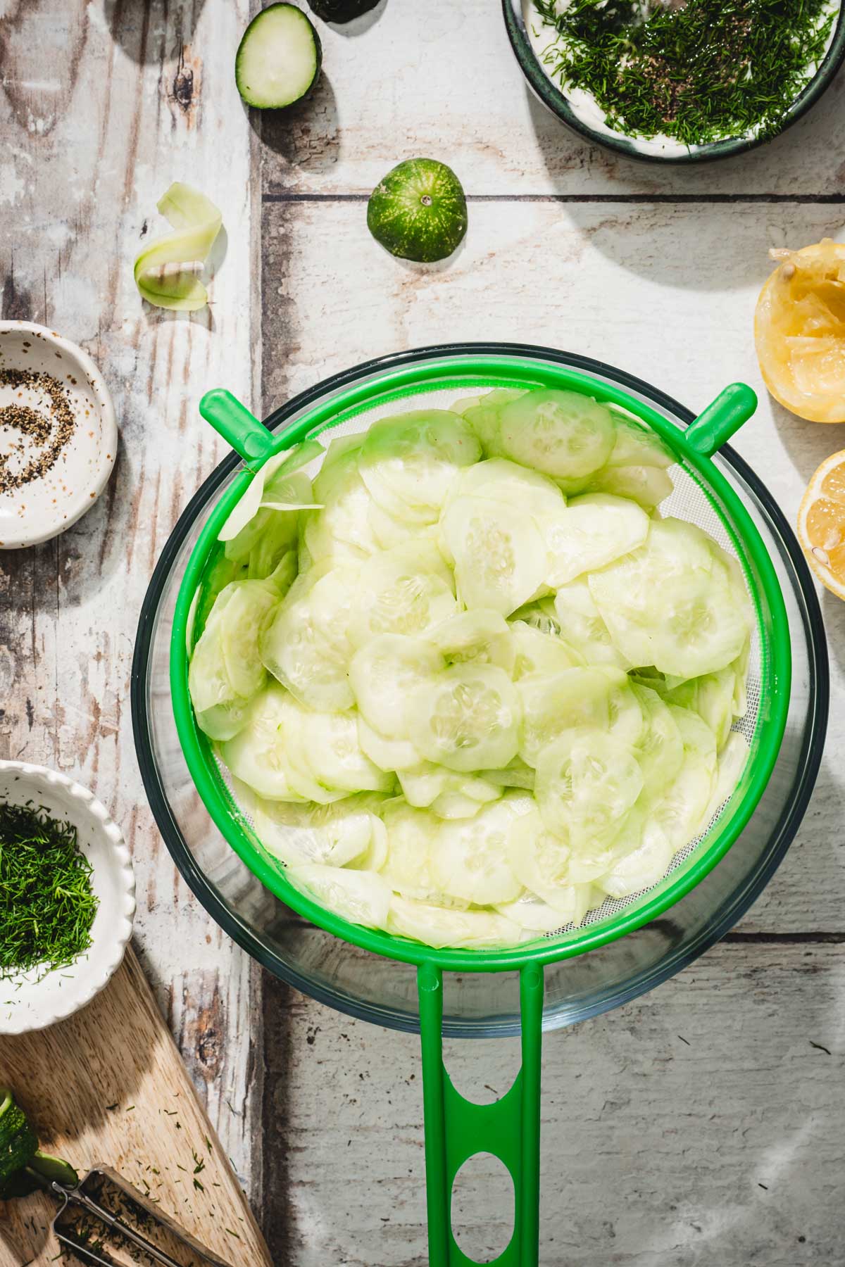 sliced cucumbers in a strainer