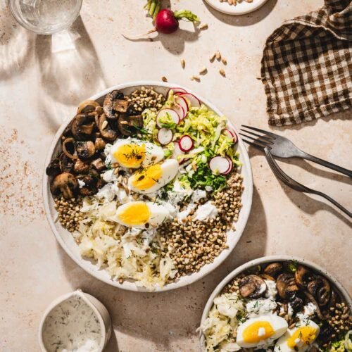 buckwheat bowl with mushrooms in a serving bowl, napkin, fok, glass with water