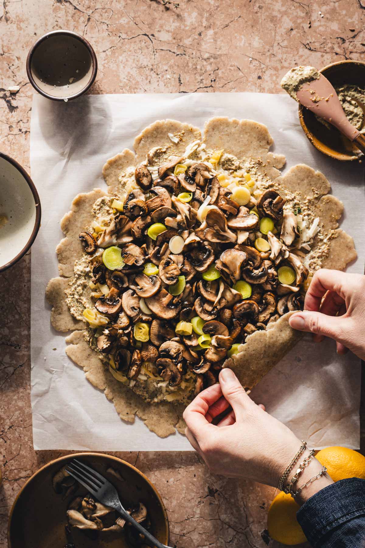 hands in frame folding the edges of the dough