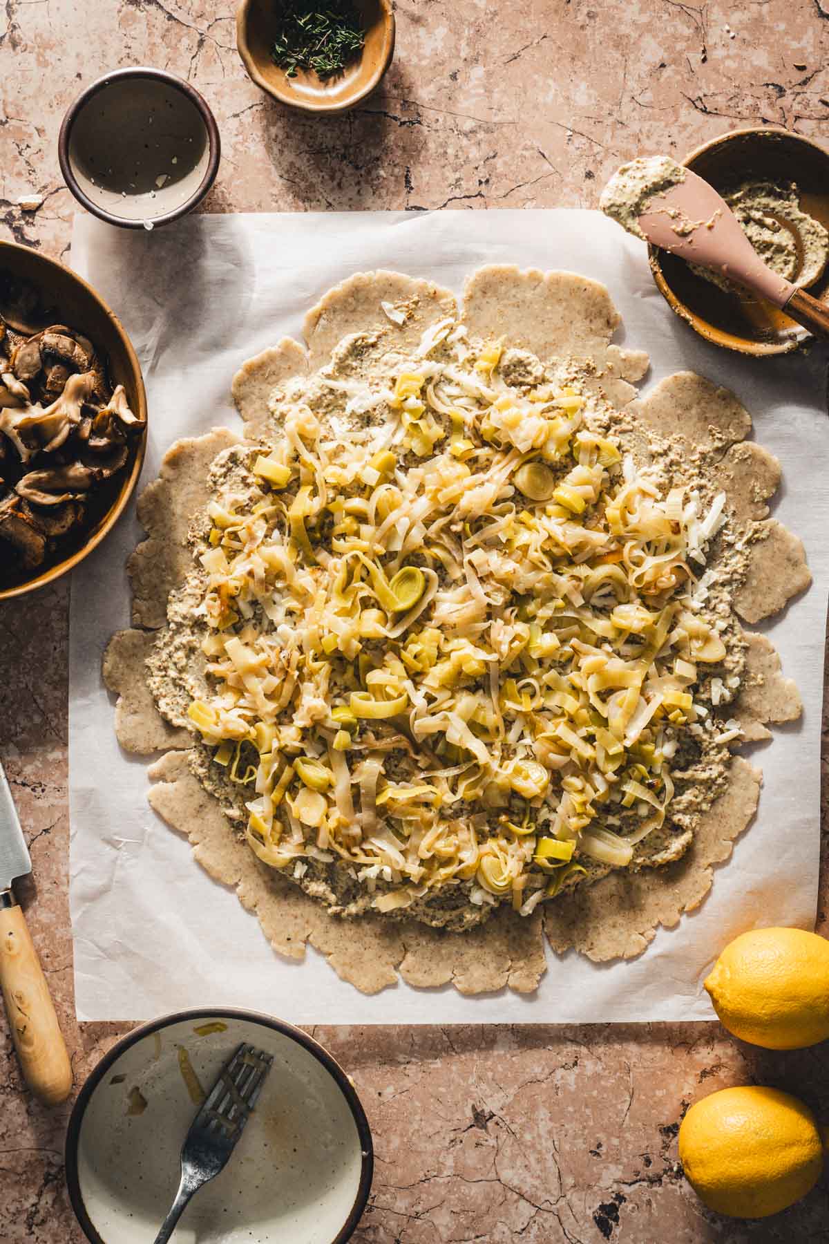 rolled out dough with mustard, cheese and leeks added