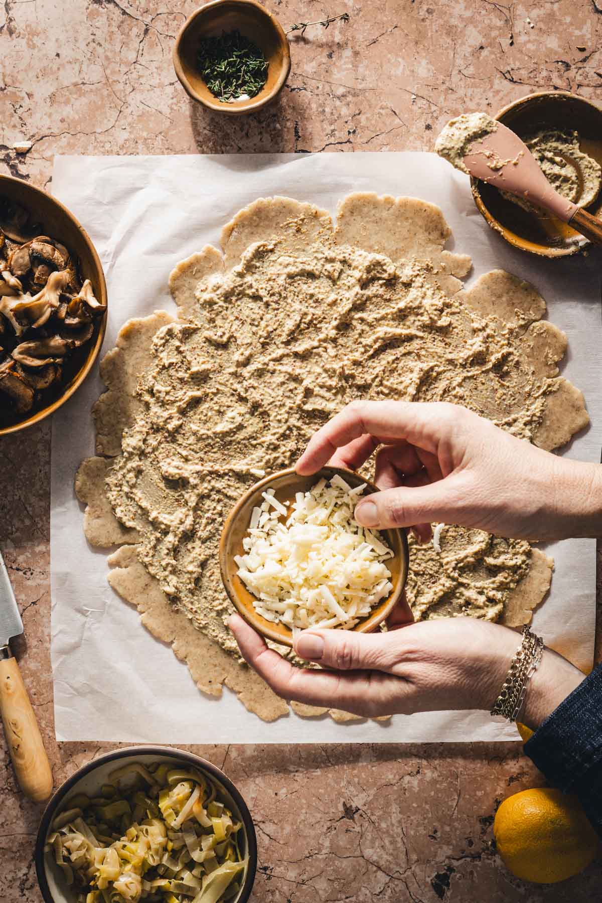 hands in frmae holding dish with cheese