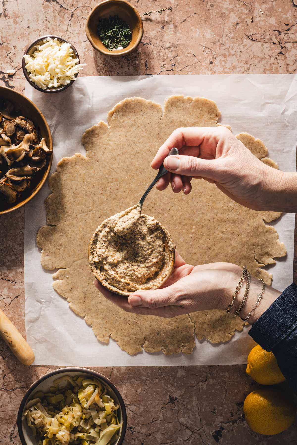 hands in frame holding dish with mustard sauce