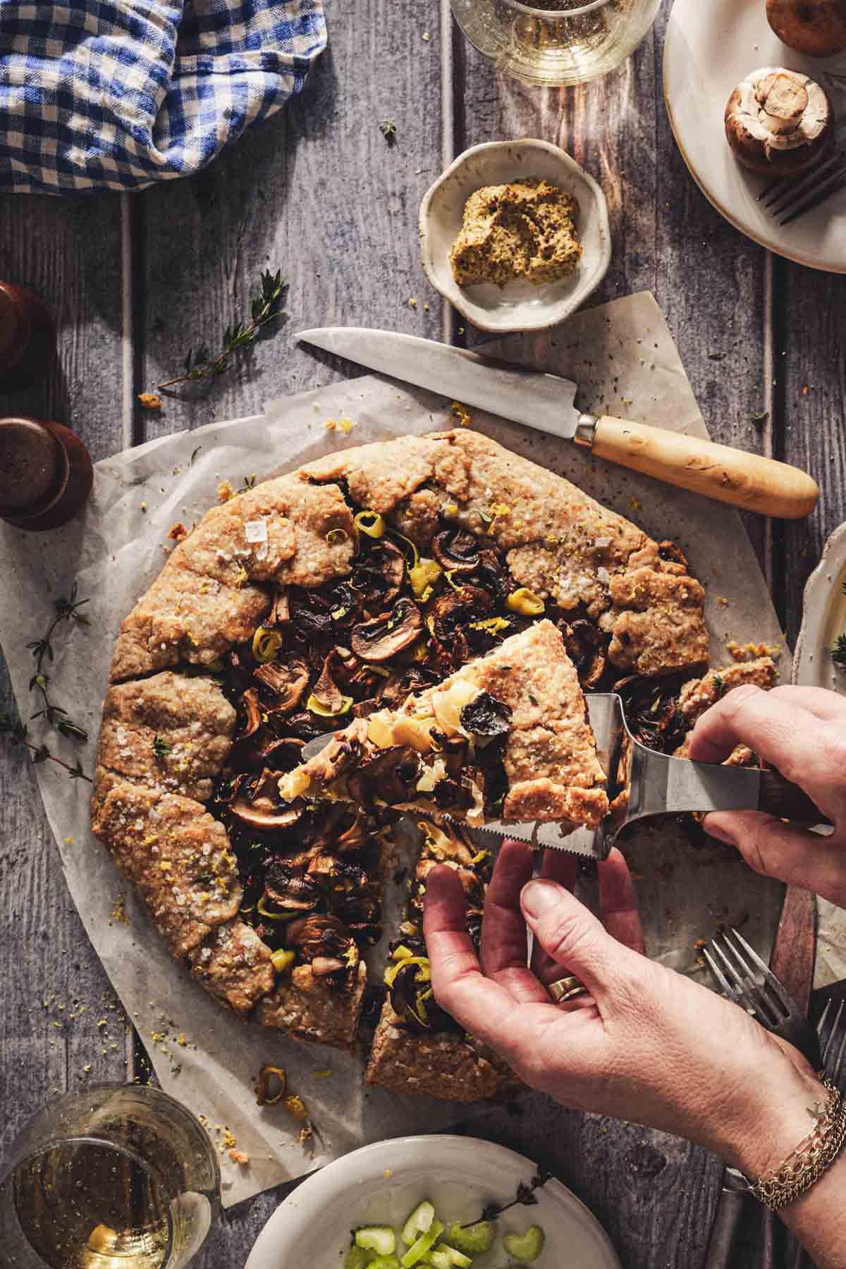 hands in frame holding a piece of galette