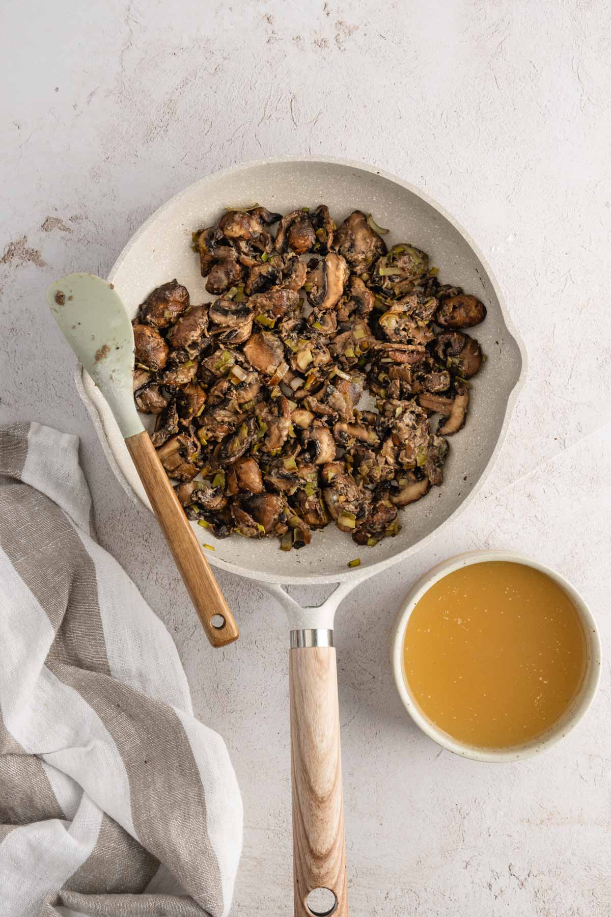 skillet with cooked mushrooms in it, dish with broth