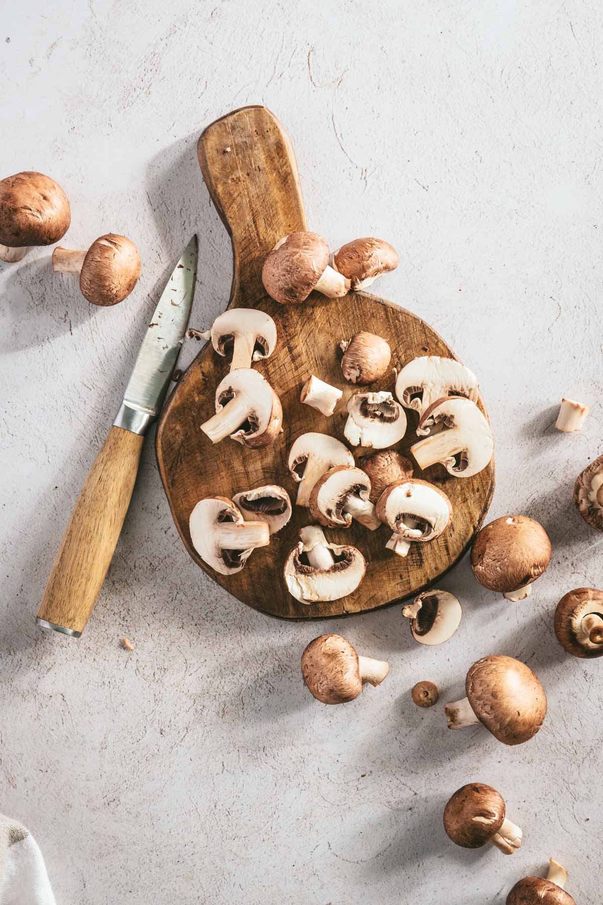 mushrooms on a cutting board, little knife