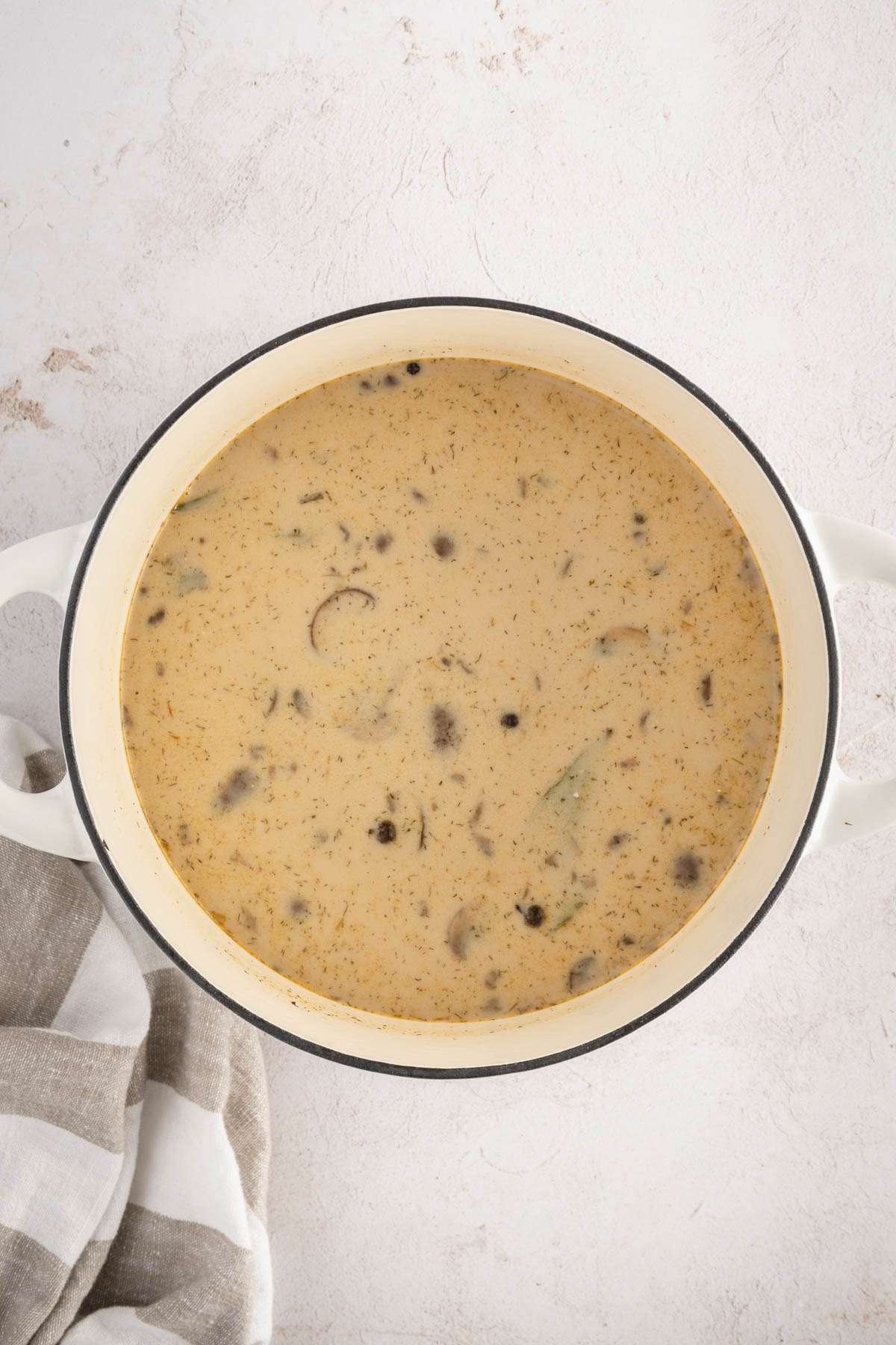 Mushroom Soup in a cooking pan, finished with sour cream sauce