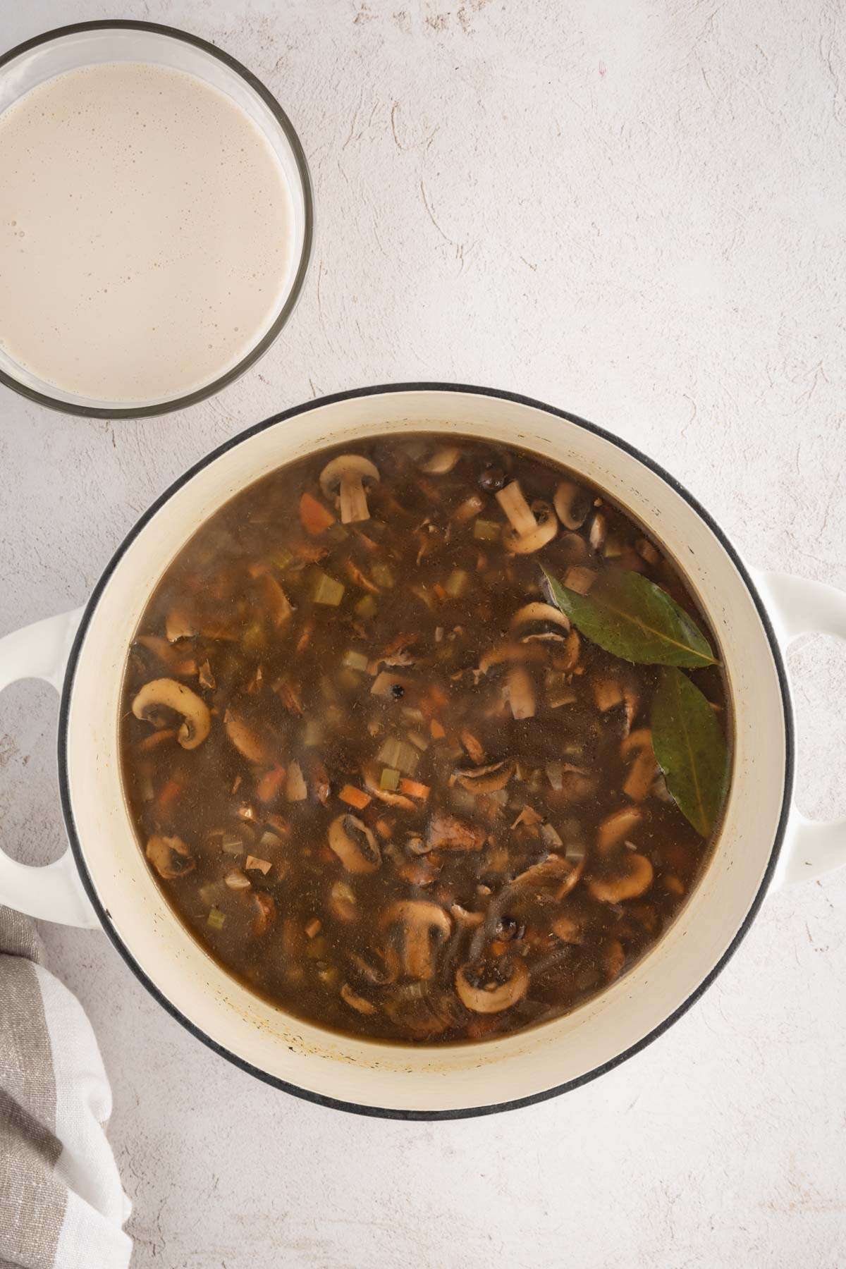 Mushroom Soup in a cooking pan, small bowl with cream