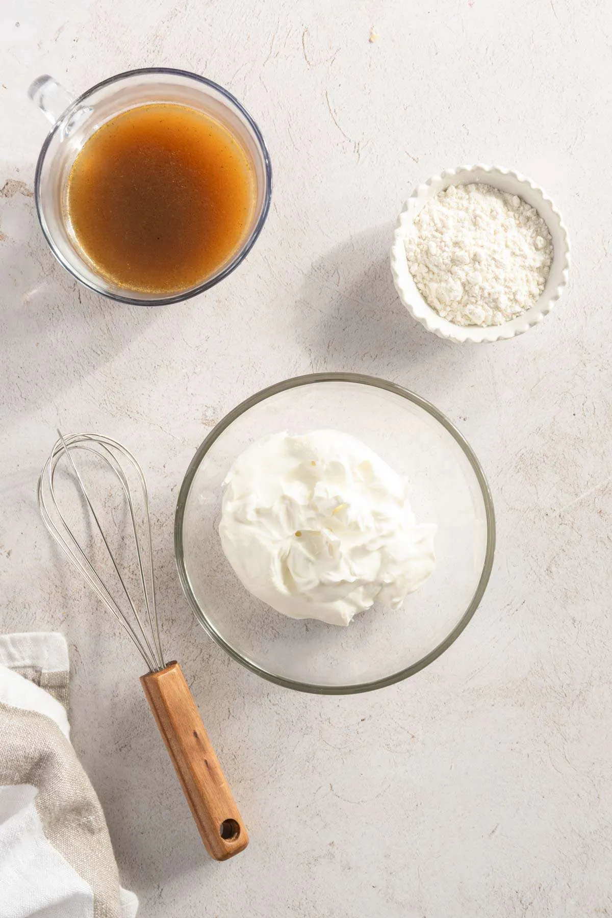 3 bowls with: Sour Cream, flour and mushroom water, whisk on the side