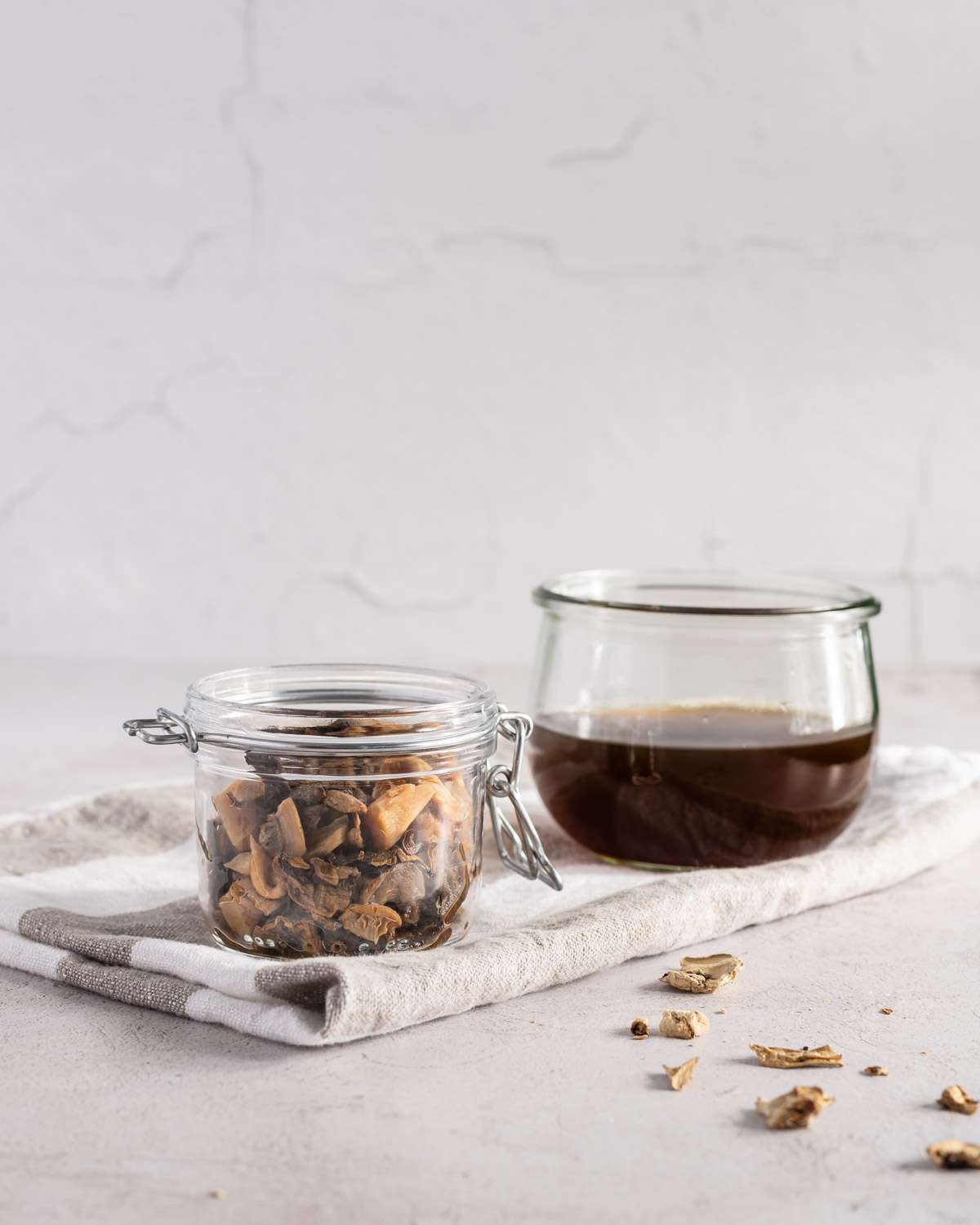 two jars, one with rehydrated mushrooms, one with mushroom water