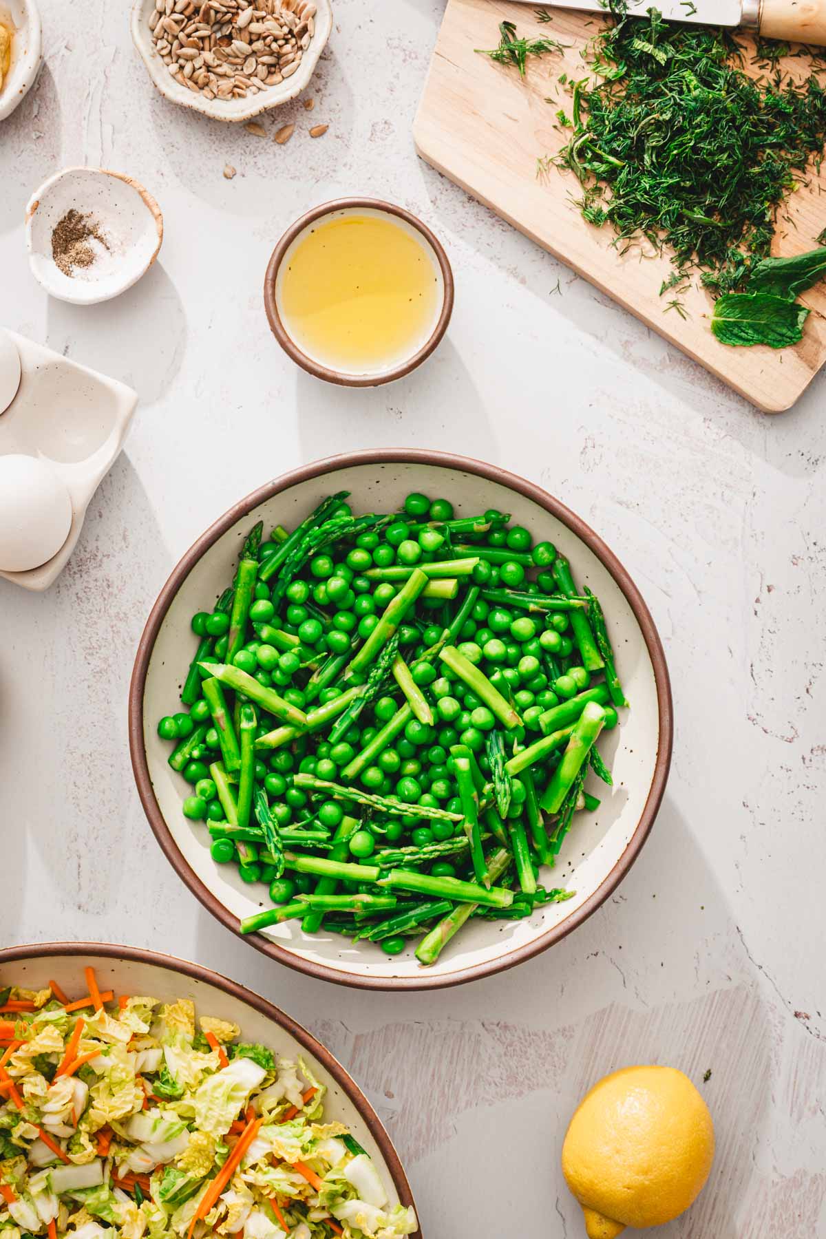 bowl with cooked asparagus and sweet peas