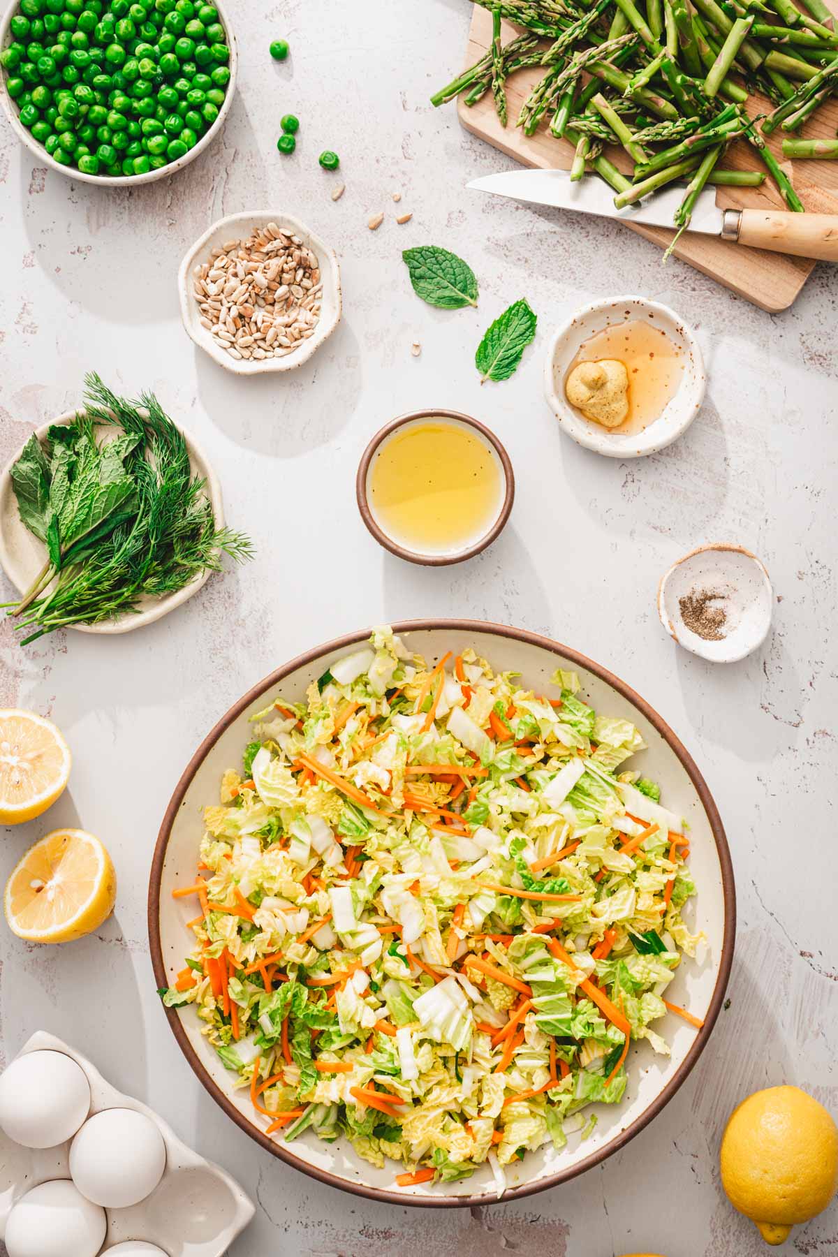 large bowl with chopped napa cabbage, other small dishes around