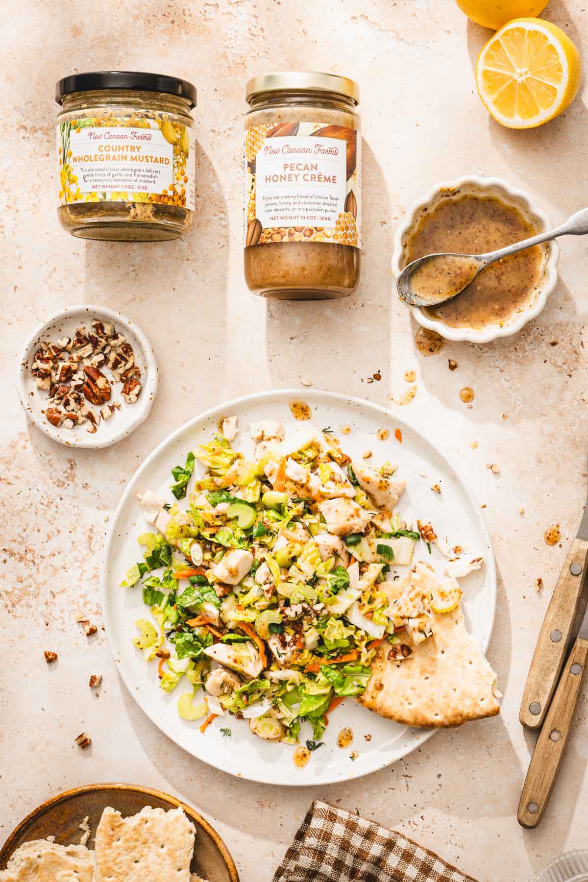 plate with napa salad, dish with dressing, serving spoon, brand jars