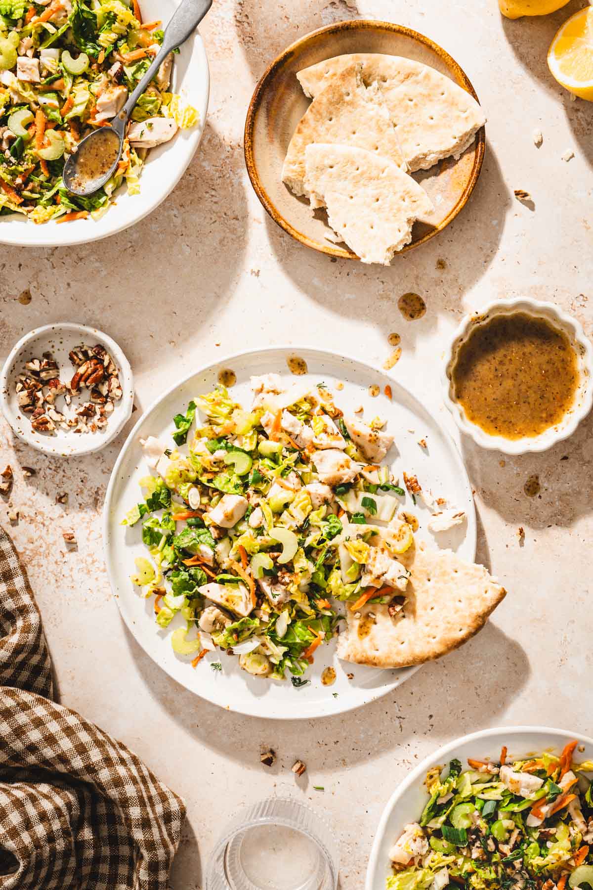 plate with napa salad, dish with dressing, toasted pecans