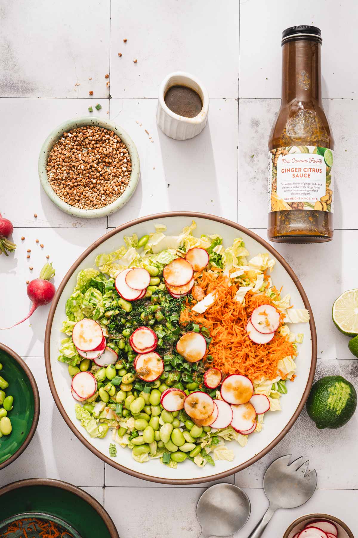 large bowl with the salad and a bottle of brand dressing