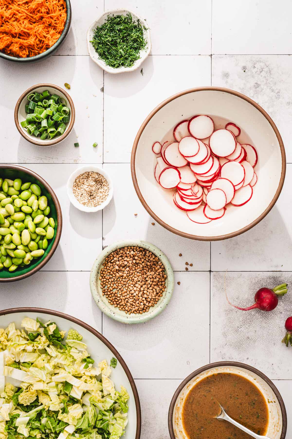 large bowl with siced radishes tossed in vinegar